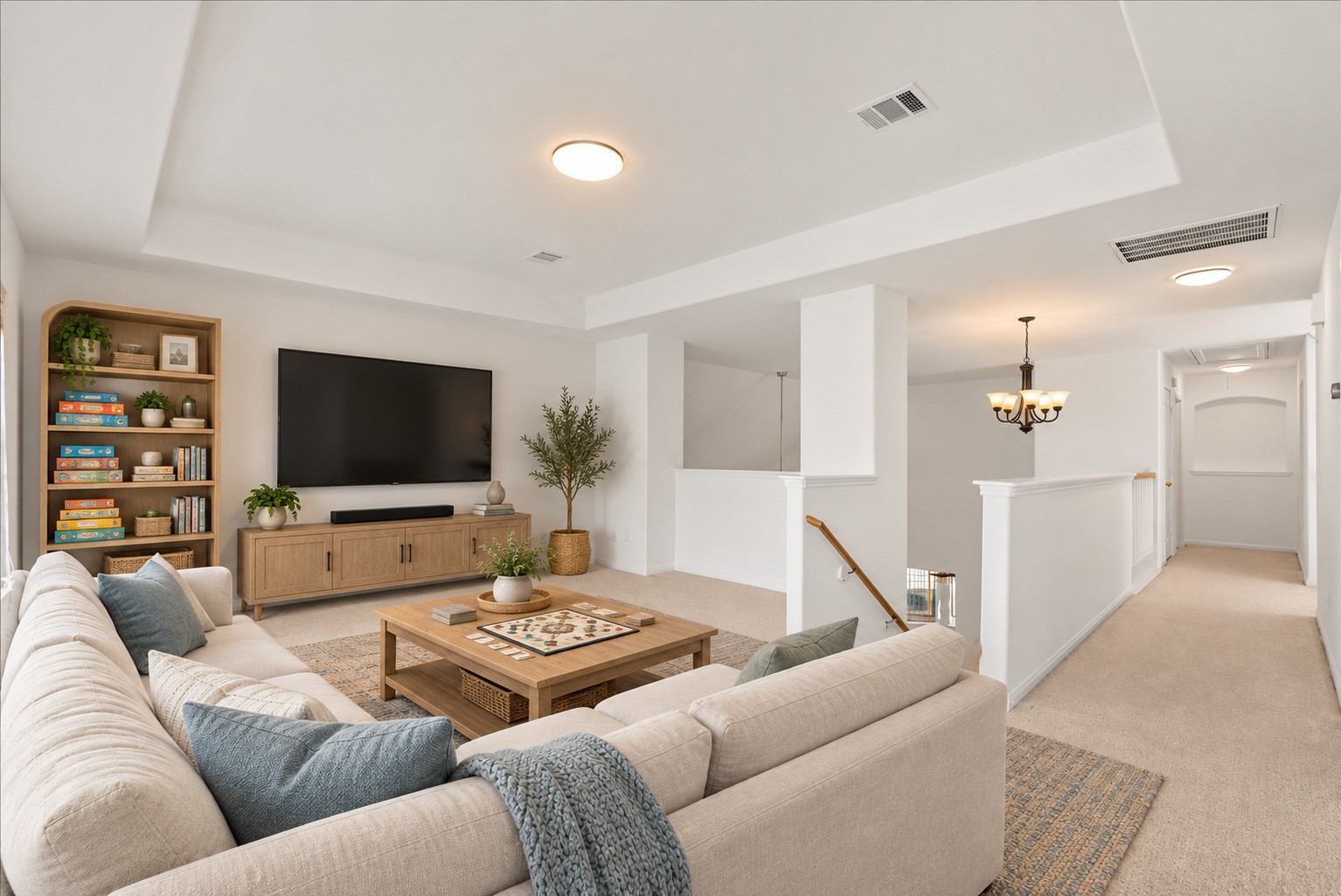 Upstairs game room with plenty of space for movie nights and game days. Virtually staged.