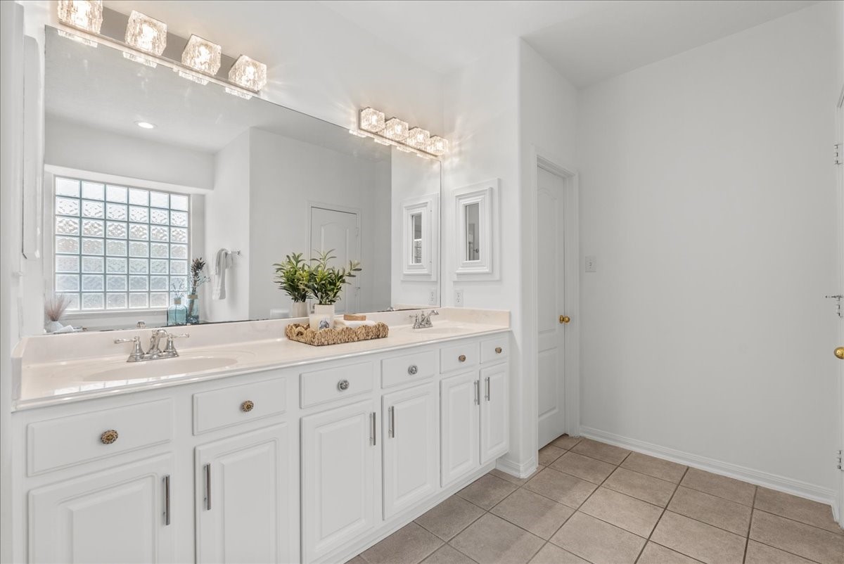 The primary bath offers a double vanity and plenty of counter space and storage.