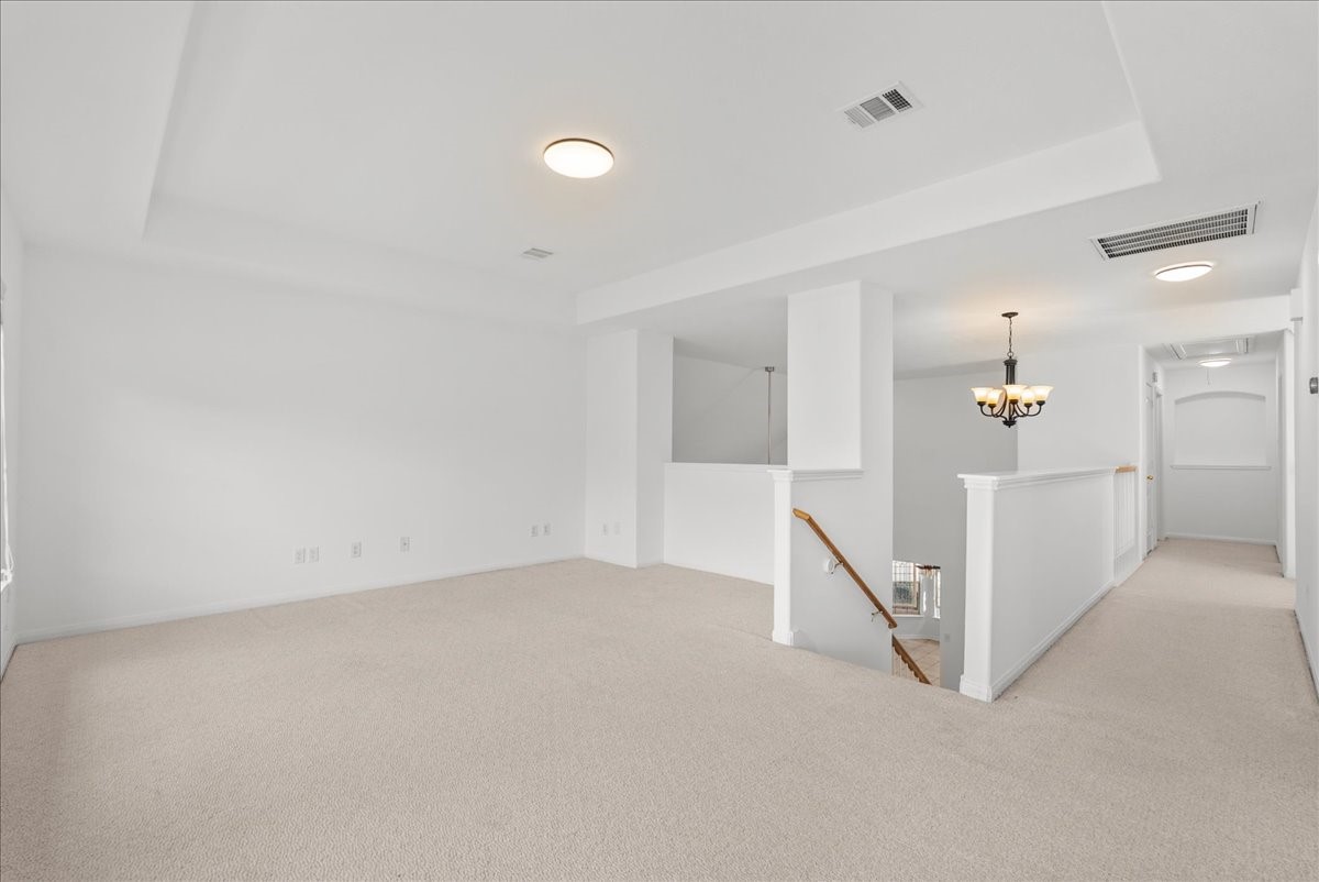 The upstairs game room is accented with a tray ceiling and plenty of room for your imagination to run wild with what to do with this space!