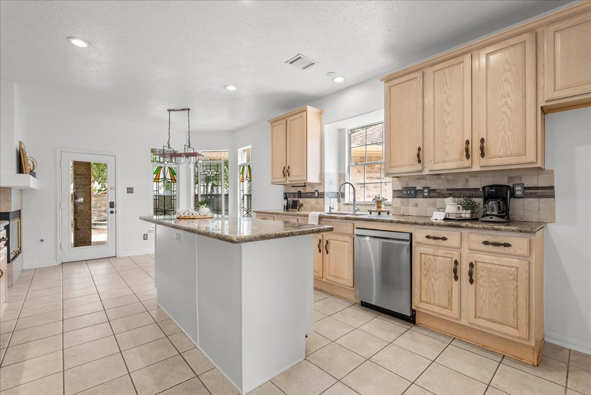 Imagine entertaining in this beautiful kitchen featuring granite countertops, stainless steel appliances, and a center island with extra storage.
