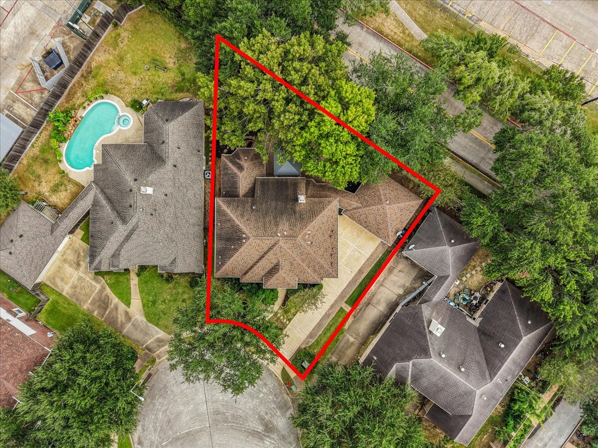 Aerial view outlining the lot, surrounded by mature trees.