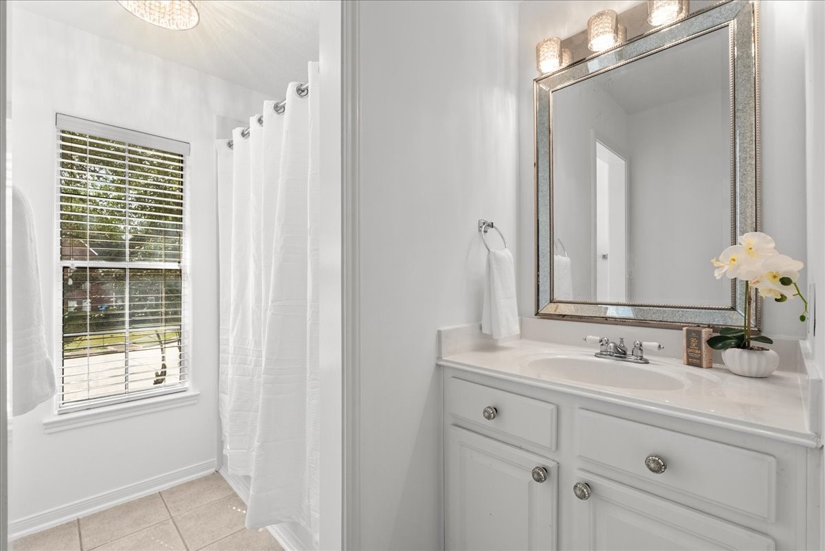 Secondary ensuite bathroom with a tub and shower combo. Added bonus and large window to let in natural light while you get ready for your day.
