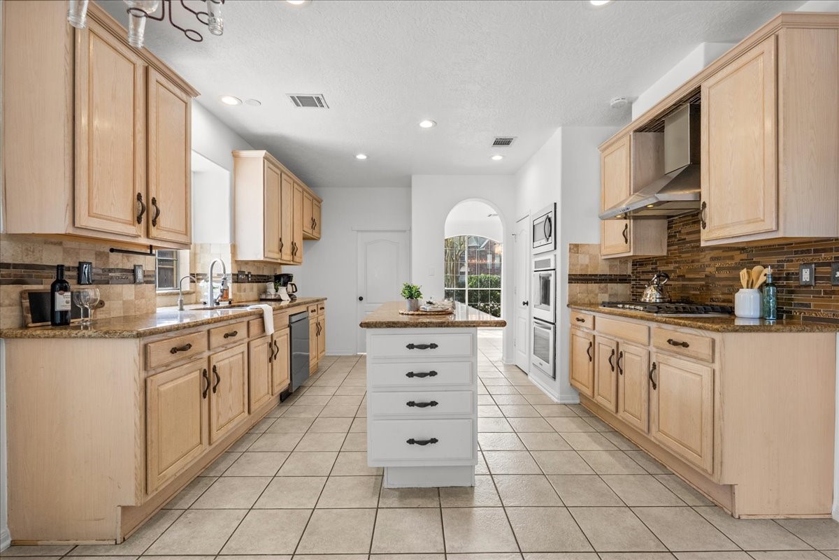 Imagine entertaining in this beautiful kitchen featuring granite countertops, stainless steel appliances, and a center island with extra storage.