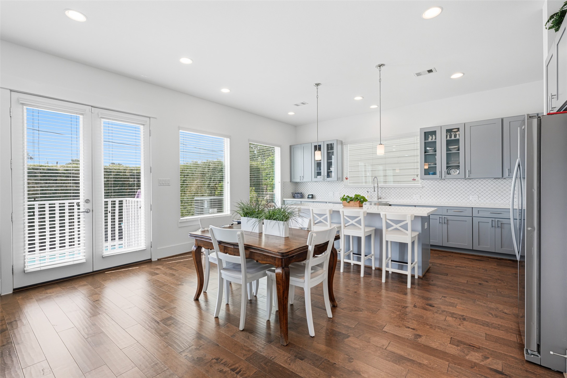 Kitchen and dining combo with more windows and view to the backyard.