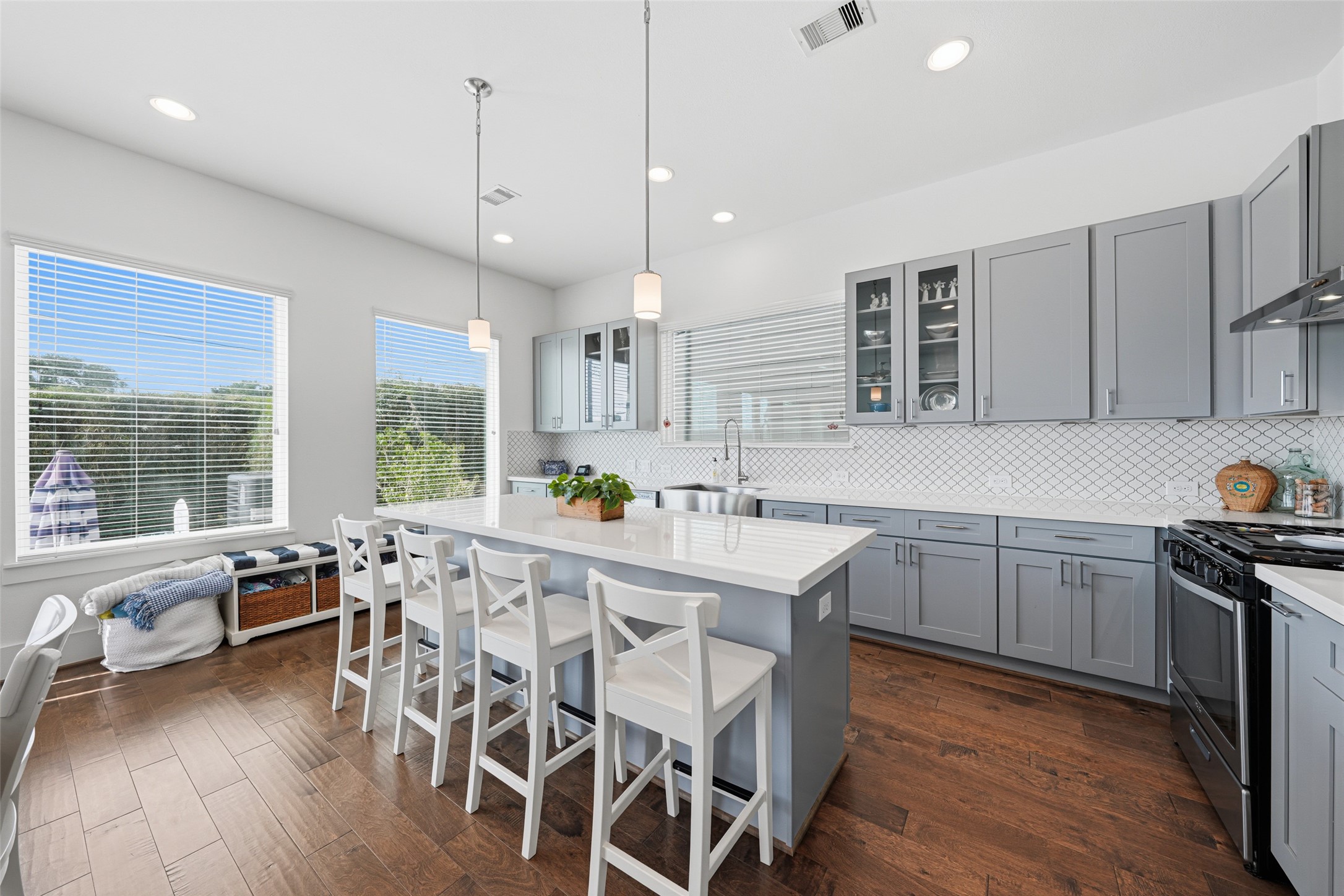 Sleek, modern kitchen with island seating, quartzite countertops and plenty of cabinet space.