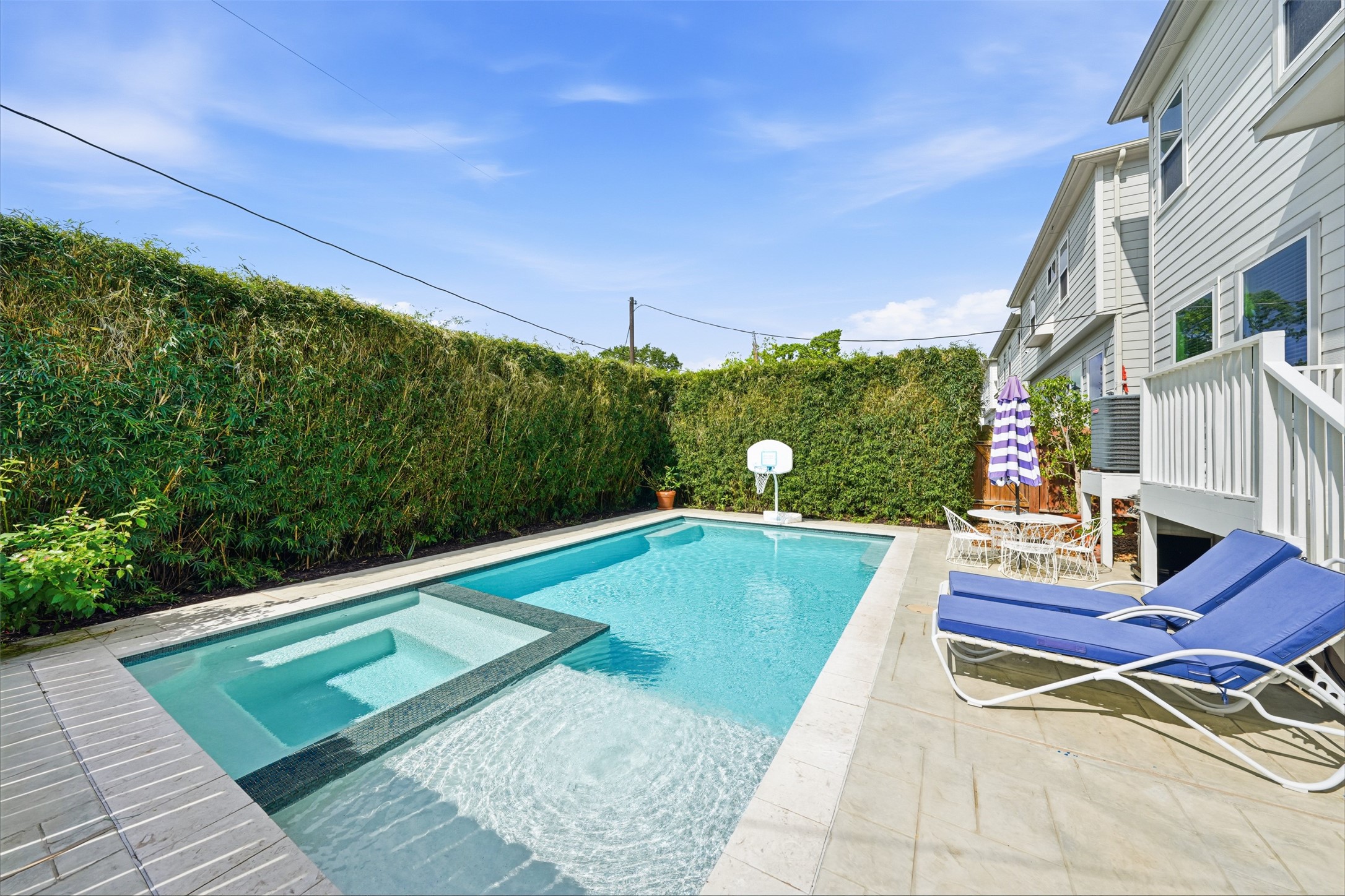 Enjoy the custom full-sized pool and hot tub with bamboo added for privacy.
