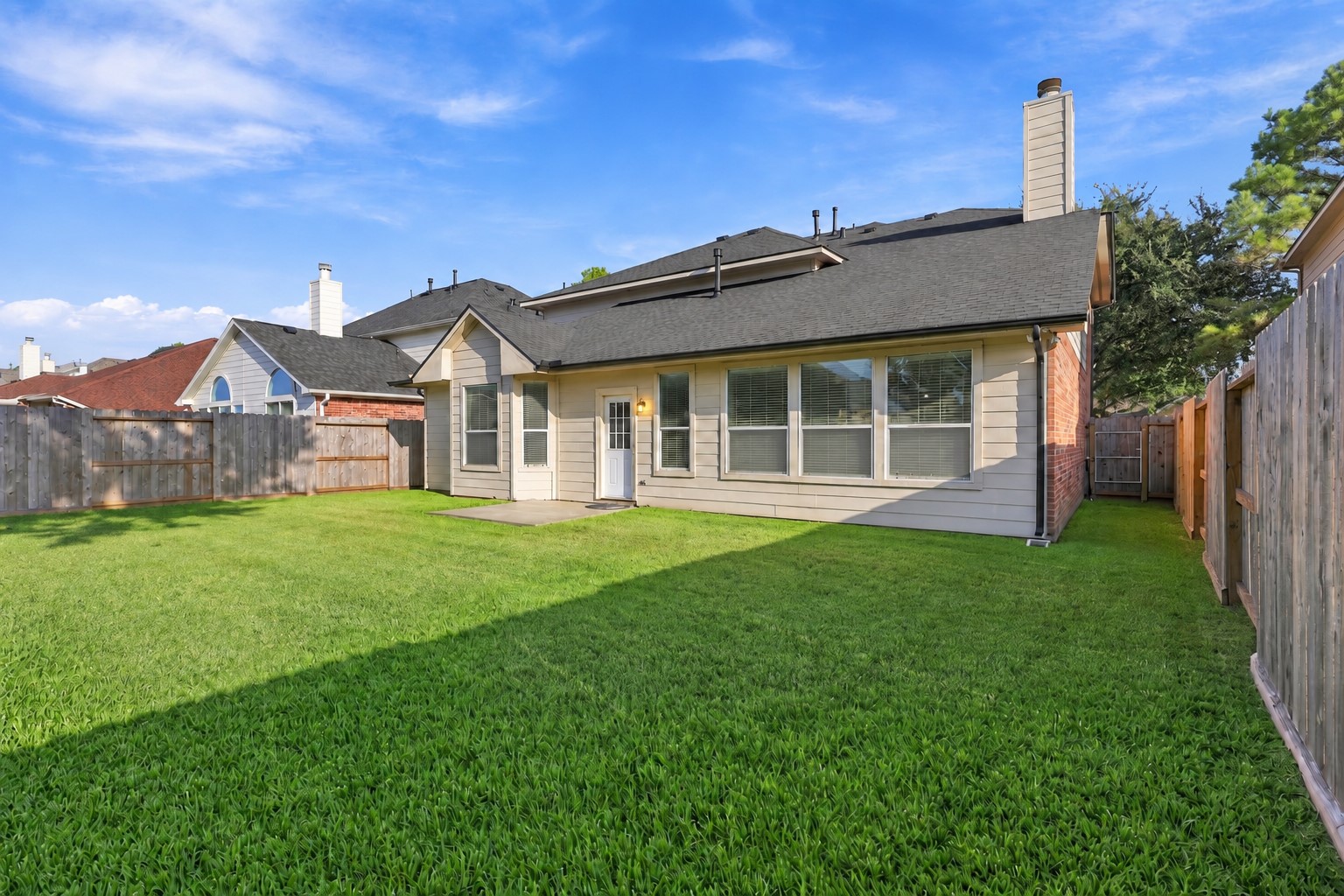 Spacious private backyard offers a beautifully maintained lawn, mature landscaping, privacy fencing, and a covered patio area. The generous outdoor space provides plenty of room for relaxing, entertaining, pets, and enjoying sunny Texas days.
