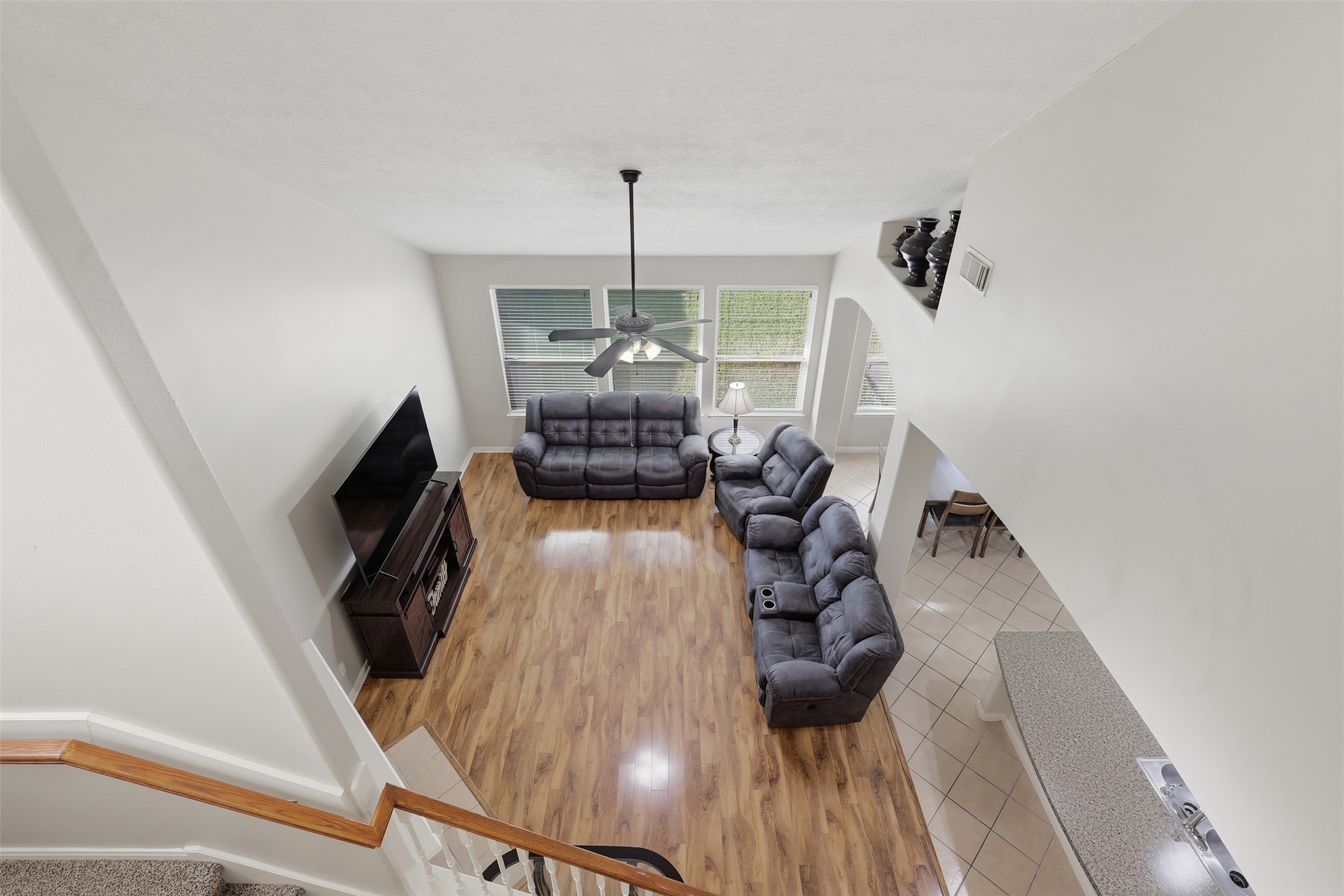 Fabulous second-floor game room overlooks the spacious family room below, creating an impressive open and connected feel. Beautiful wood-look flooring, abundant natural light, and generous space make this an ideal area for games, entertaining, or family fun.