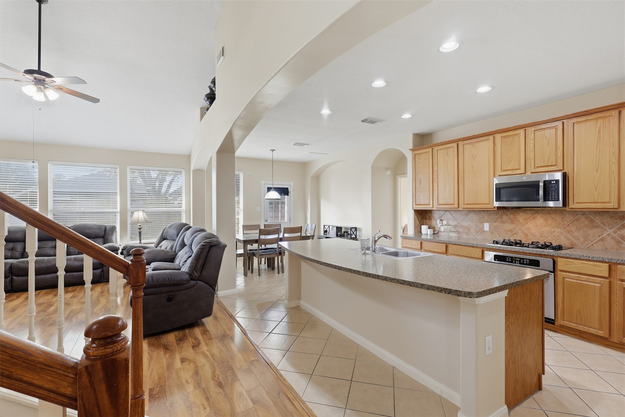Enjoy the spacious open-concept layout seamlessly connecting the family room and gourmet kitchen. Soaring ceilings, abundant recessed lighting, wood-look flooring, and a large island create an inviting space perfect for everyday living and entertaining. Just add your barstools and savor watching culinary masterpieces come to life!
