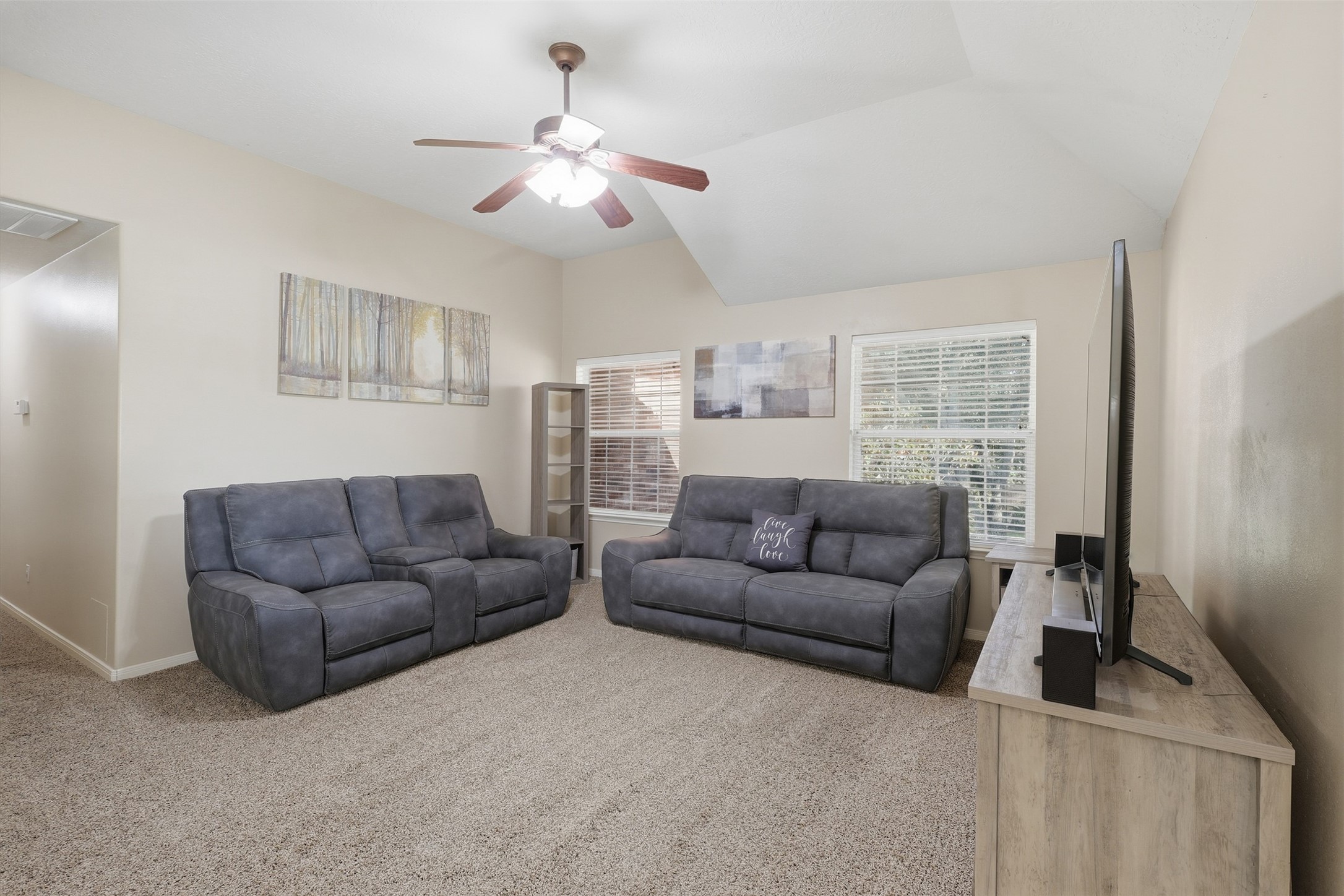 Spacious upstairs game room provides ample space for relaxing, entertaining, and family fun. Featuring plush carpeting, a ceiling fan, large windows, and an open layout, its an inviting spot for game nights, movie watching, or casual lounging. This area is also ideal for a pool table or other recreational activities.