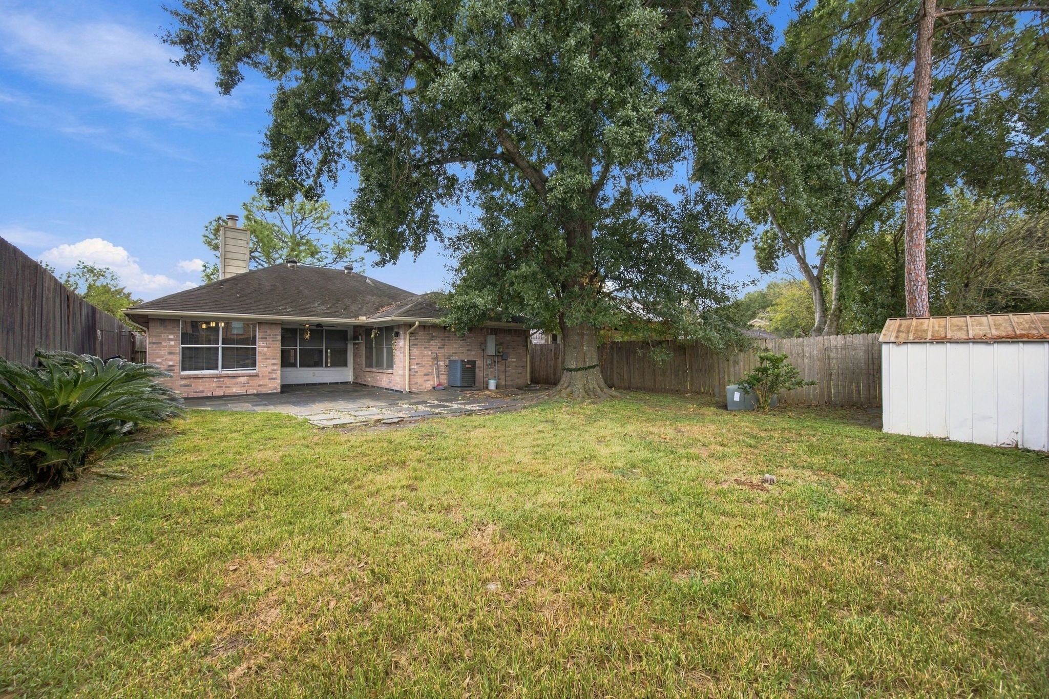 A spacious, fenced backyard offers room for gardening, outdoor activities, and entertaining.