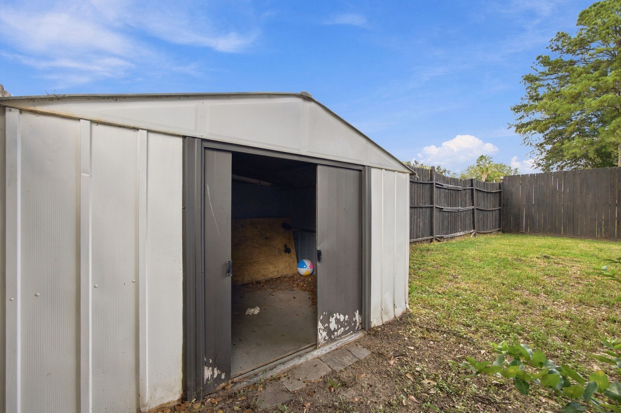 A backyard storage shed provides additional space for lawn equipment, gardening tools, and outdoor supplies.