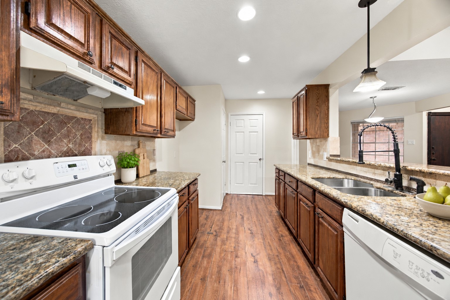 Generous counter space and upper and lower cabinetry provide plenty of room for meal preparation and storage. Virtually staged