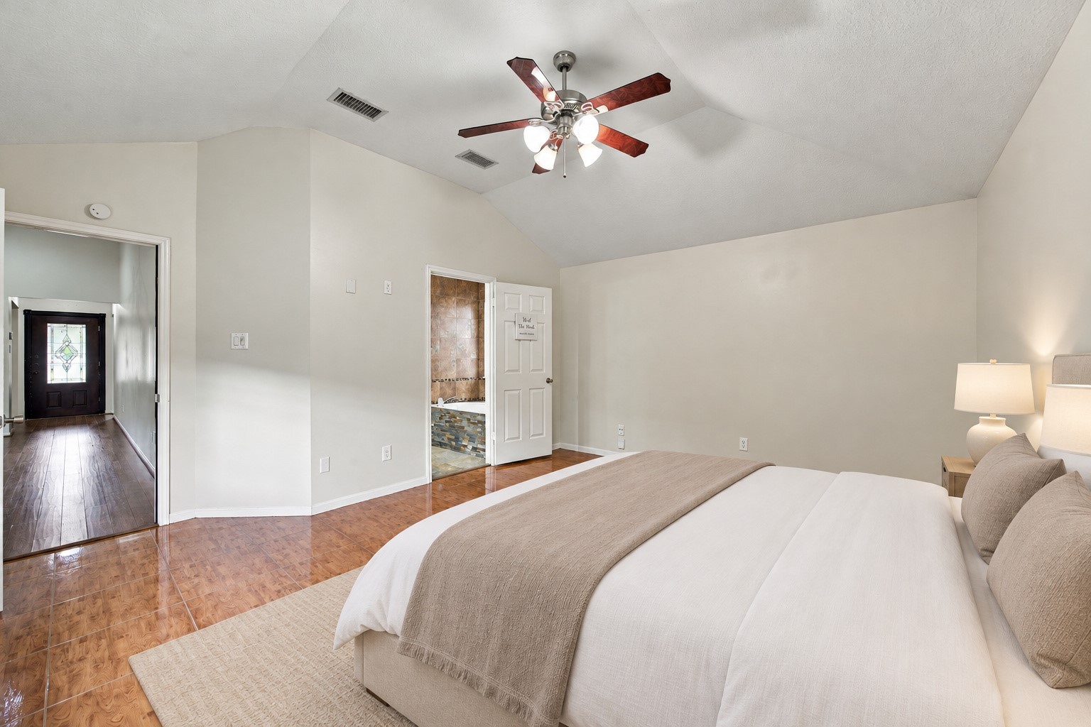 Broad walls offer options for placing a bed, dresser, and additional seating. Virtually staged