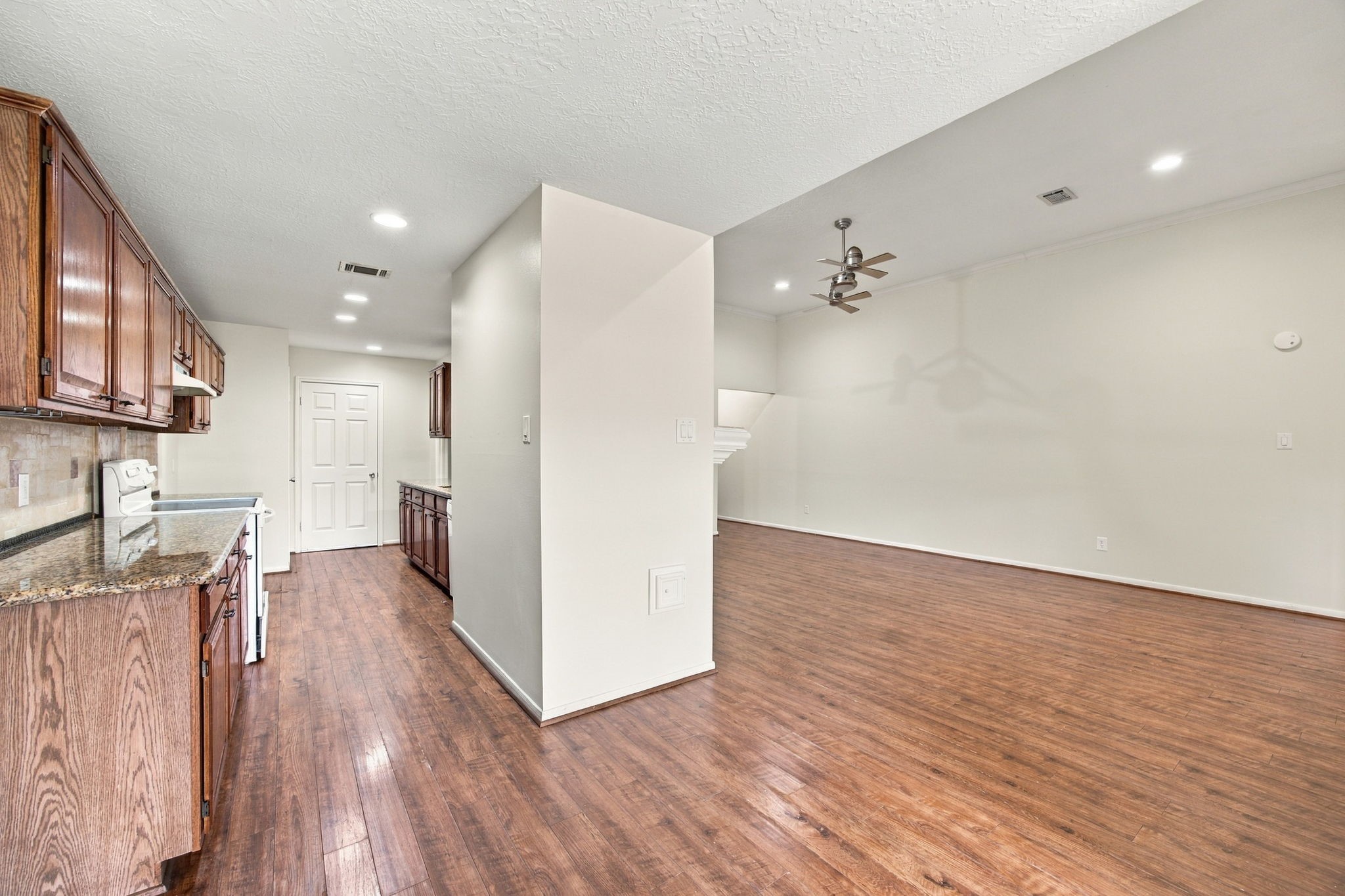 The kitchen sits alongside the living room, keeping everyday cooking and gathering spaces conveniently connected.