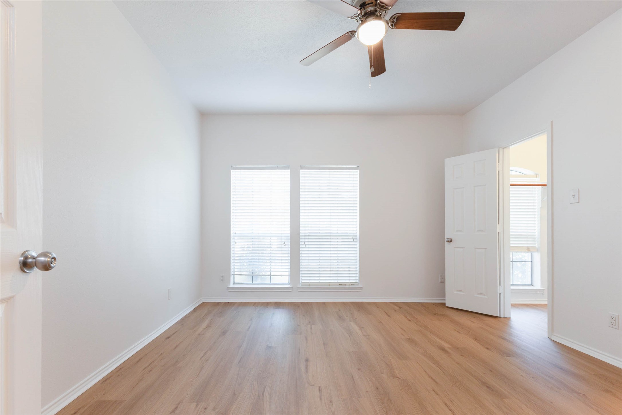 Beautifully refreshed, this generously sized first floor secondary bedroom features brand-new luxury vinyl plank flooring, crisp white walls, & a ceiling fan with lighting. Two large windows fill the room with natural light, while the open, airy layout easily accommodates a variety of bedroom furnishings.*