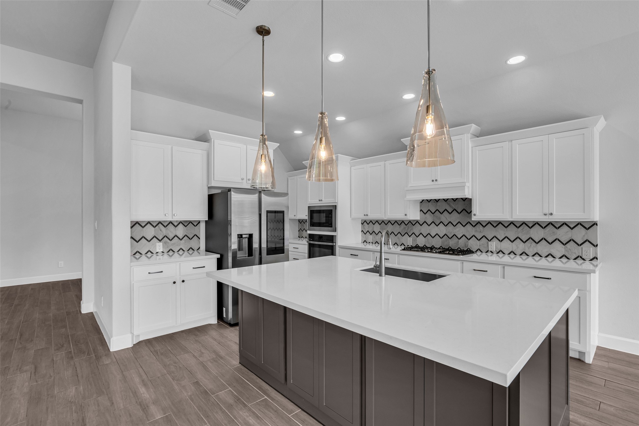 Island kitchen with upgraded stone and backsplash