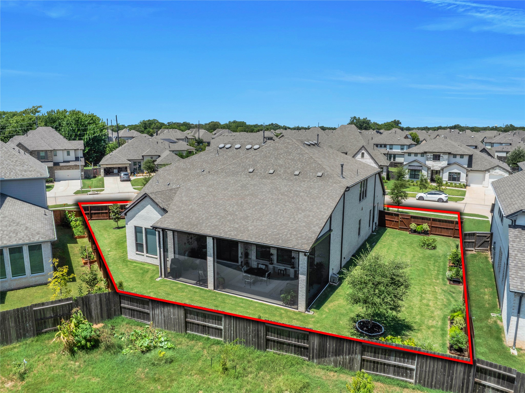 The aerial view showcases this expansive 14,000+ square-foot lot, offering ample room to design the pool and backyard oasis of your dreams.