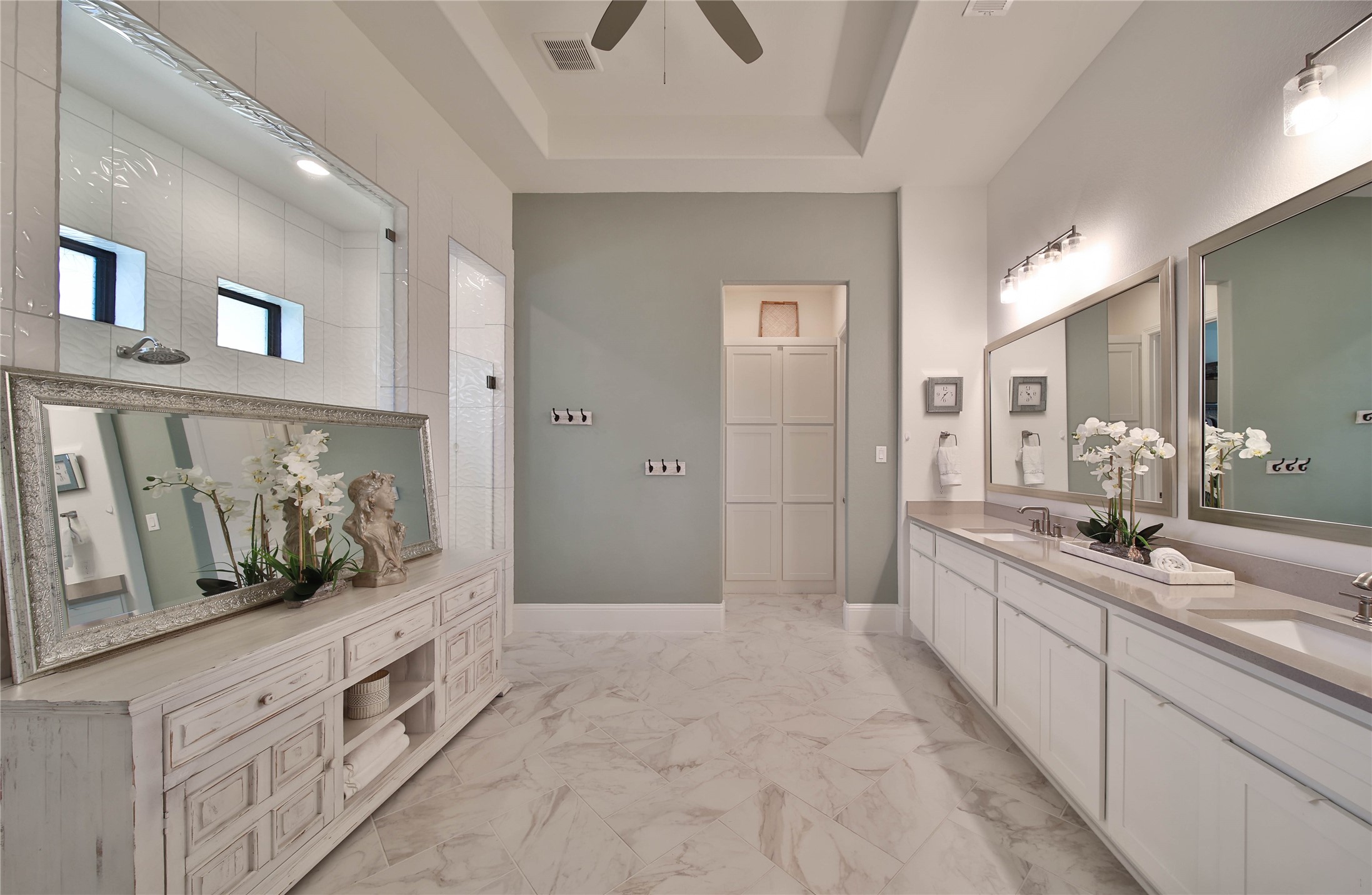 A luxurious primary bath offers plenty of space for two, creating a comfortable and inviting setting to start the day.