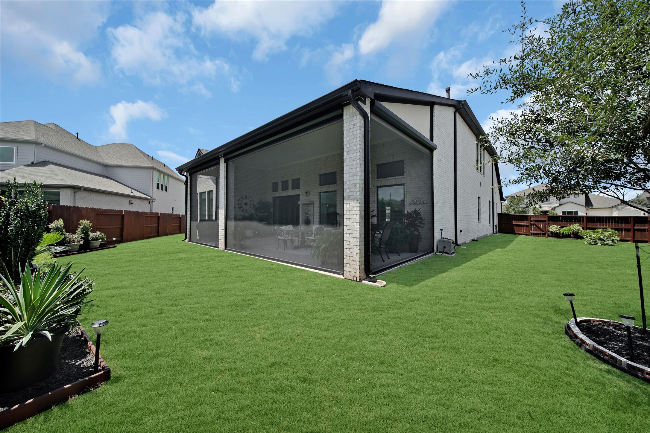 The back patio features remote-controlled screens divided into four customizable zones, allowing you to enjoy them fully open, fully closed, or anywhere in between.