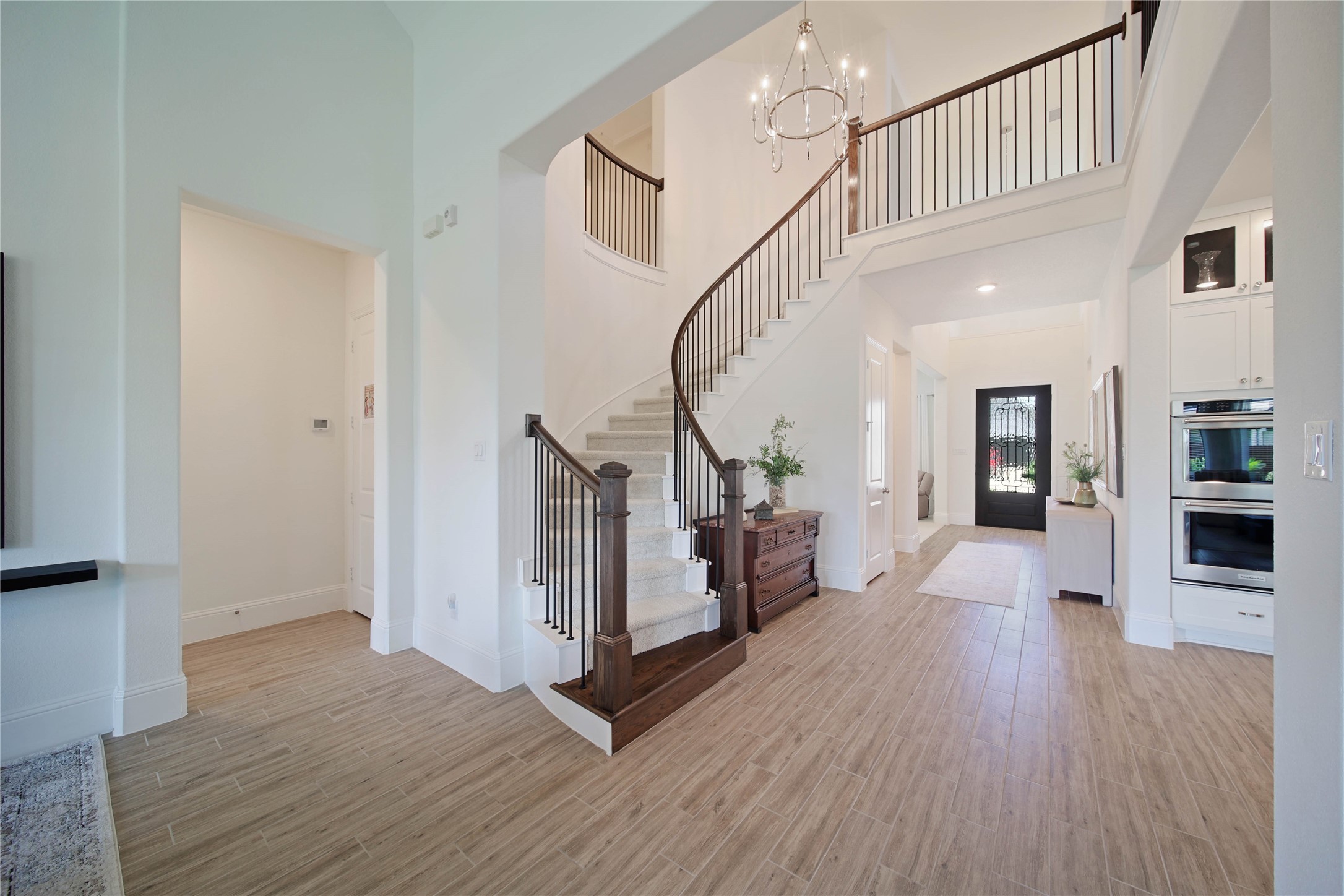 Wood look tile planks grace the entry and flow seamlessly into the main living areas.