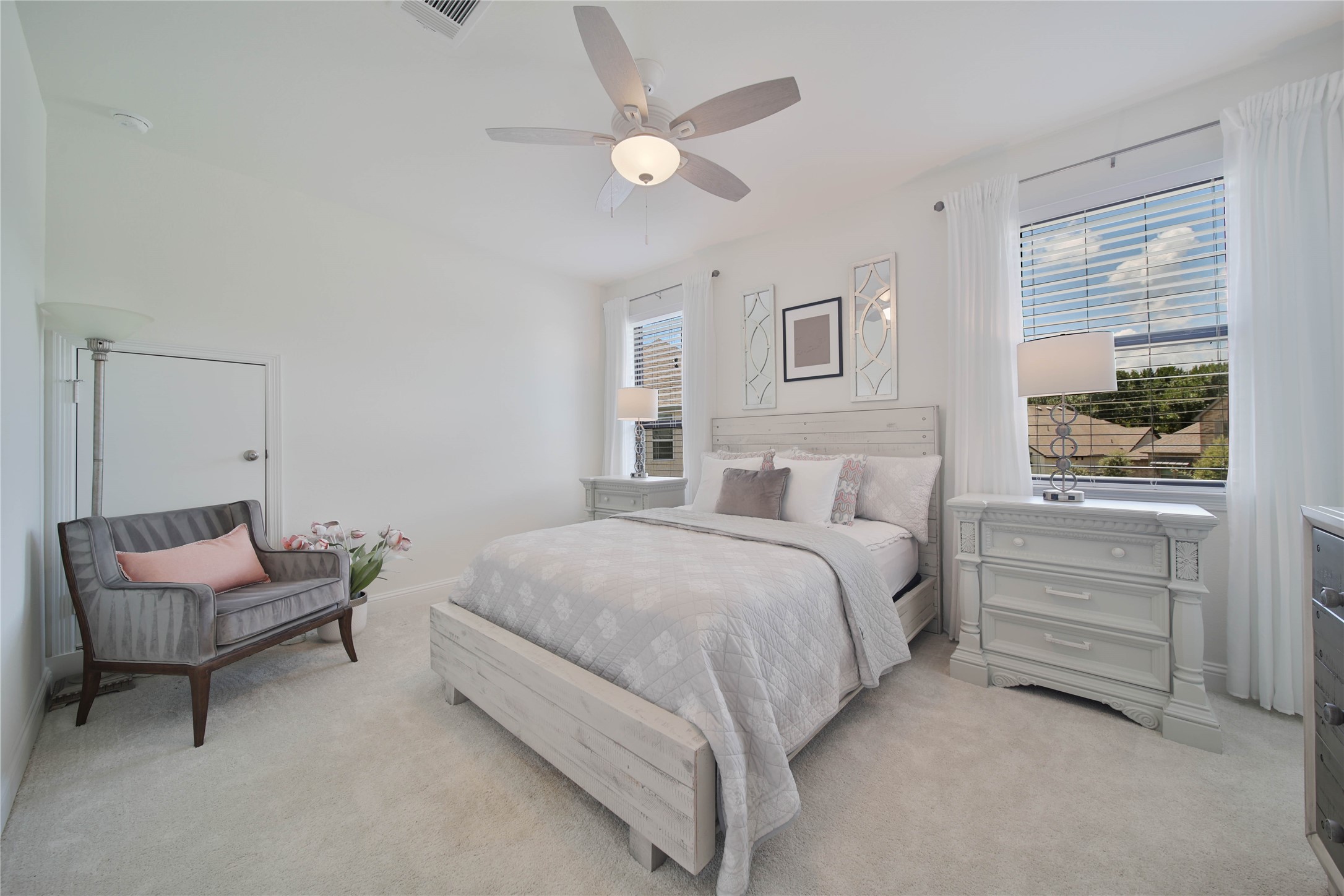Another generously sized bedroom offers plenty of room to relax and unwind, complete with a ceiling fan and spacious walk-in closet.