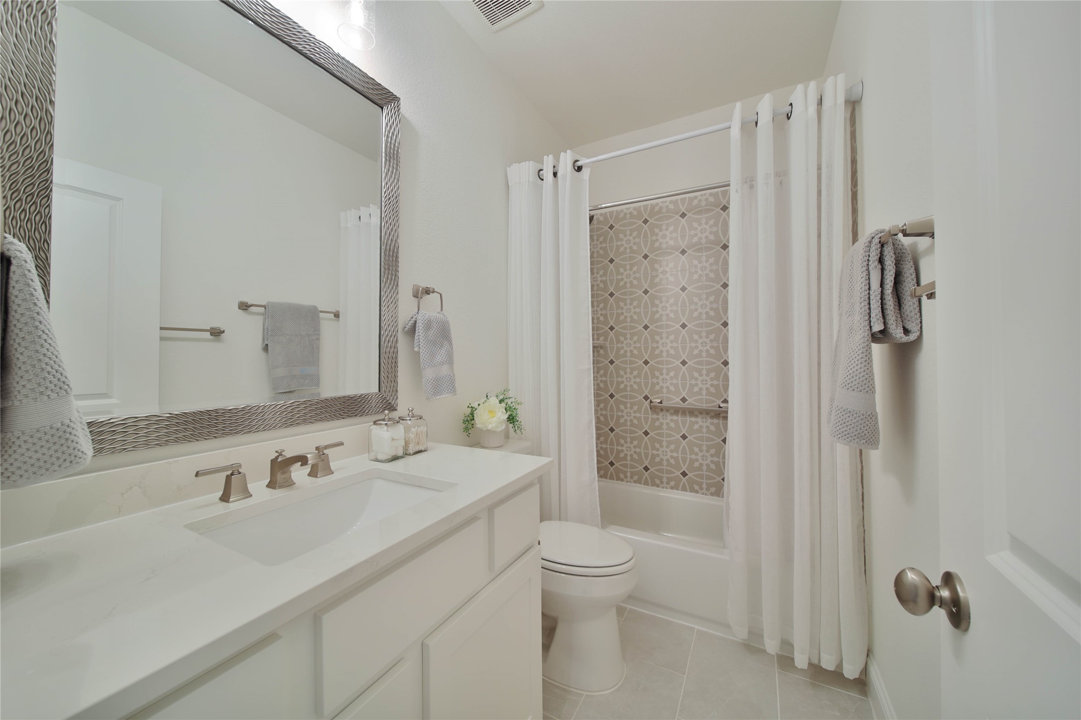 A conveniently located full bathroom in the hallway provides easy access for family members and guests alike.