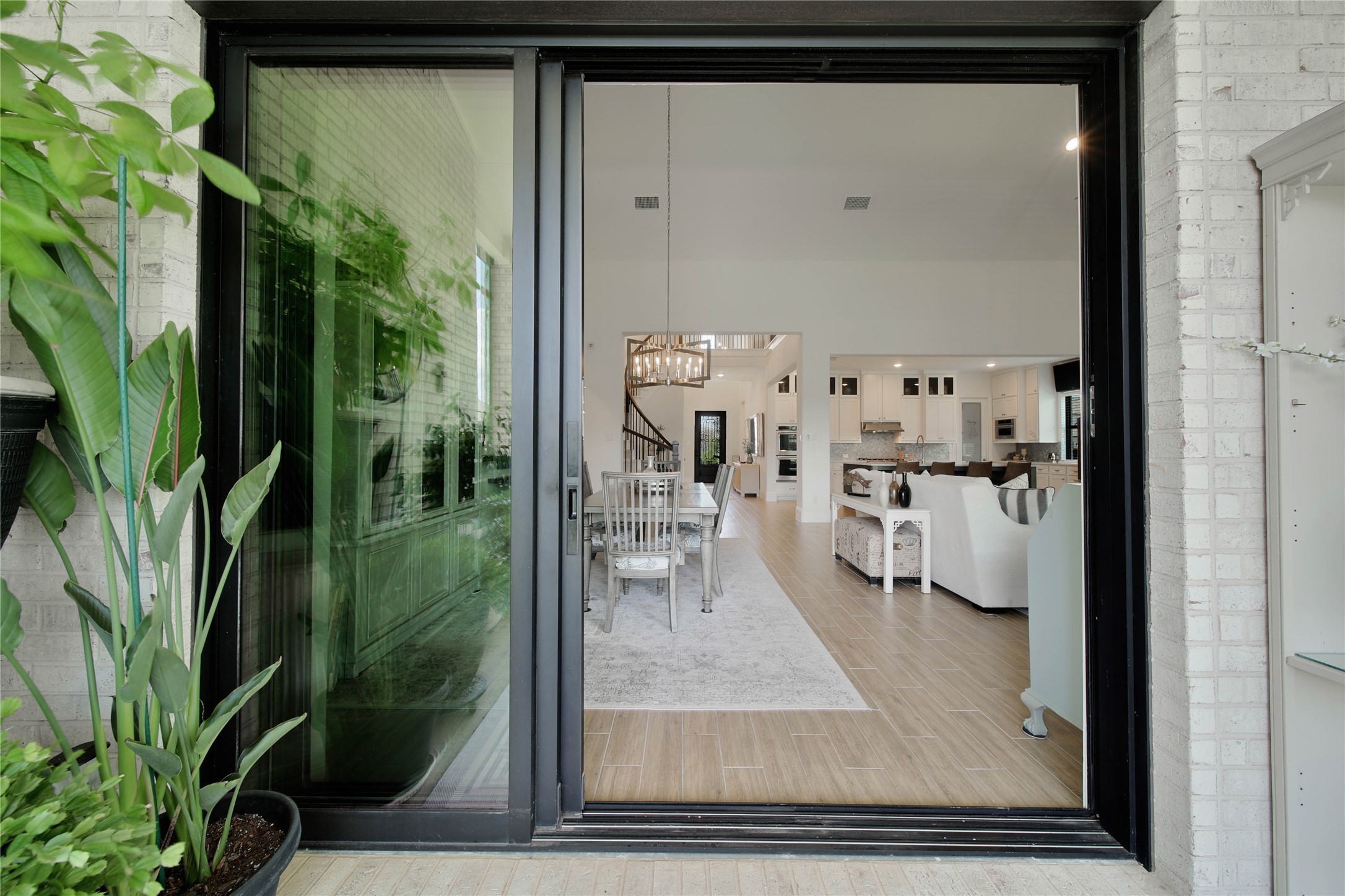 The multi track sliding doors in the dining area stack wide open, seamlessly blending the indoor and outdoor spaces and creating an incredible setting for entertaining on the back patio.
