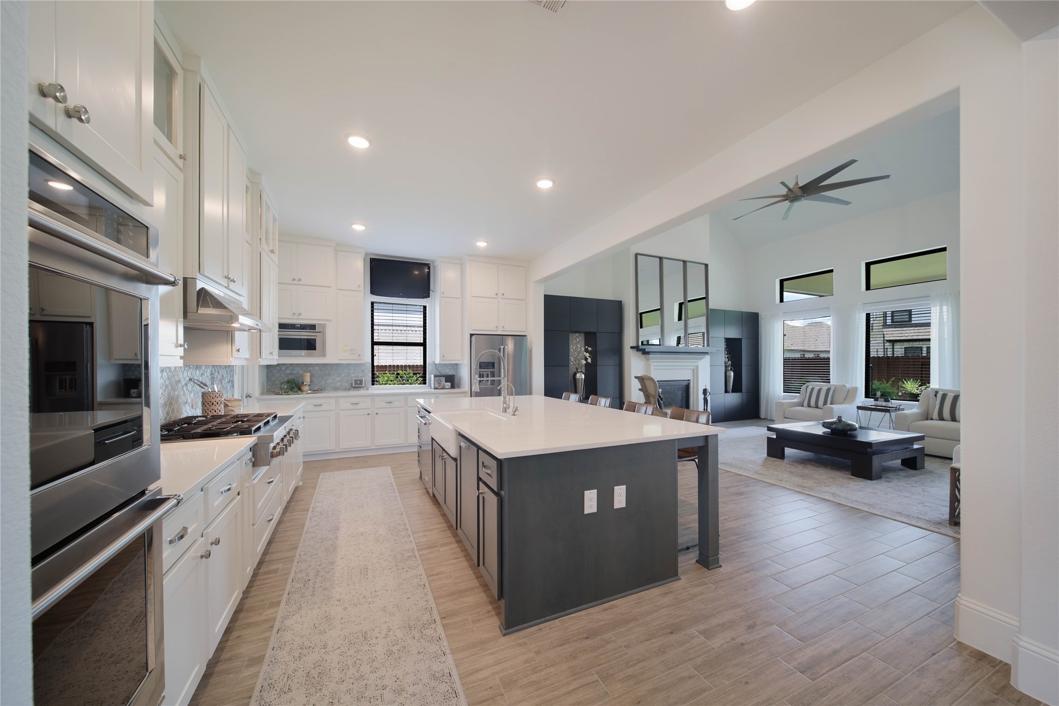 Top-tier KitchenAid stainless steel appliances, including double ovens and a six-burner gas cooktop, create a chef-inspired kitchen that any culinary enthusiast will appreciate.