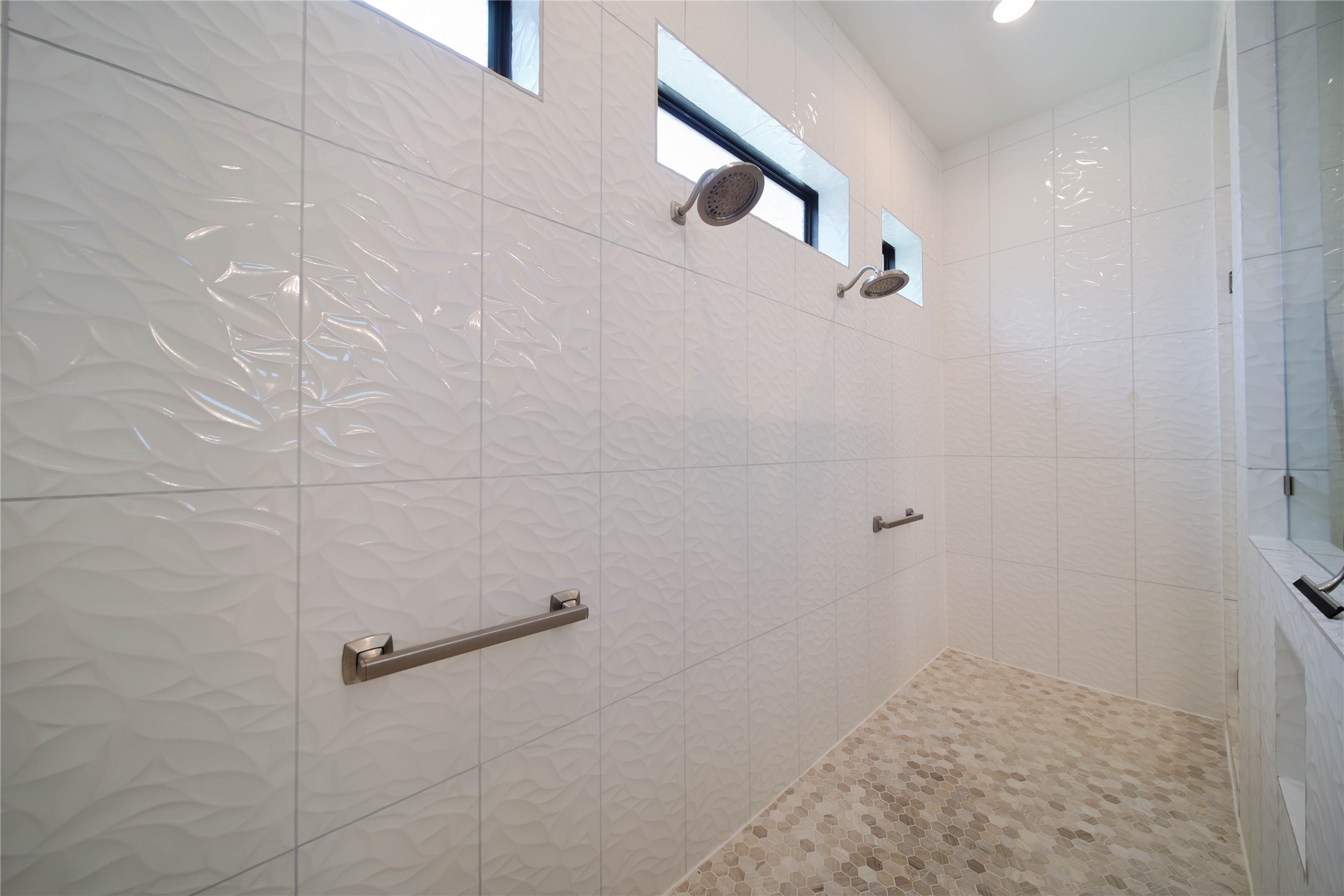 The pass-through shower features dual showerheads, creating a spa-like experience with added convenience.