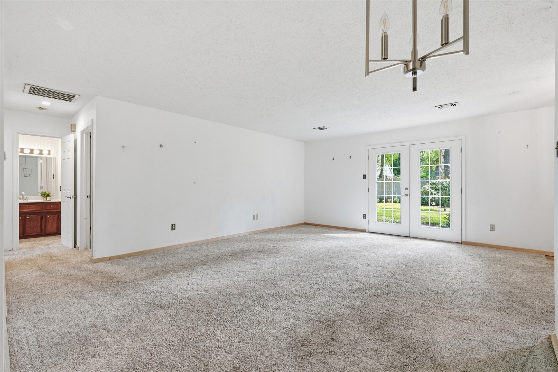 Living room with double doors to back yard Living room with double doors to back yard