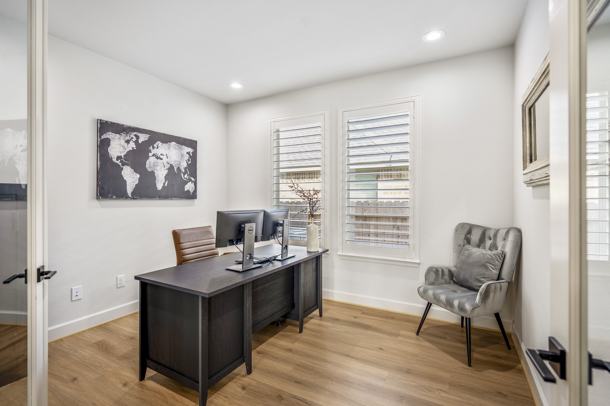 This inviting home office creates a welcoming workspace. It's light and bright with the added recessed lighting.