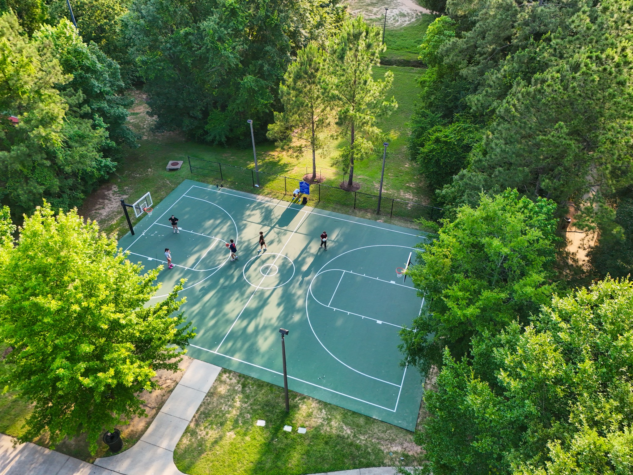 Perfect for sports enthusiasts and families, the area offers a peaceful, natural environment with surrounding trees and walking paths.