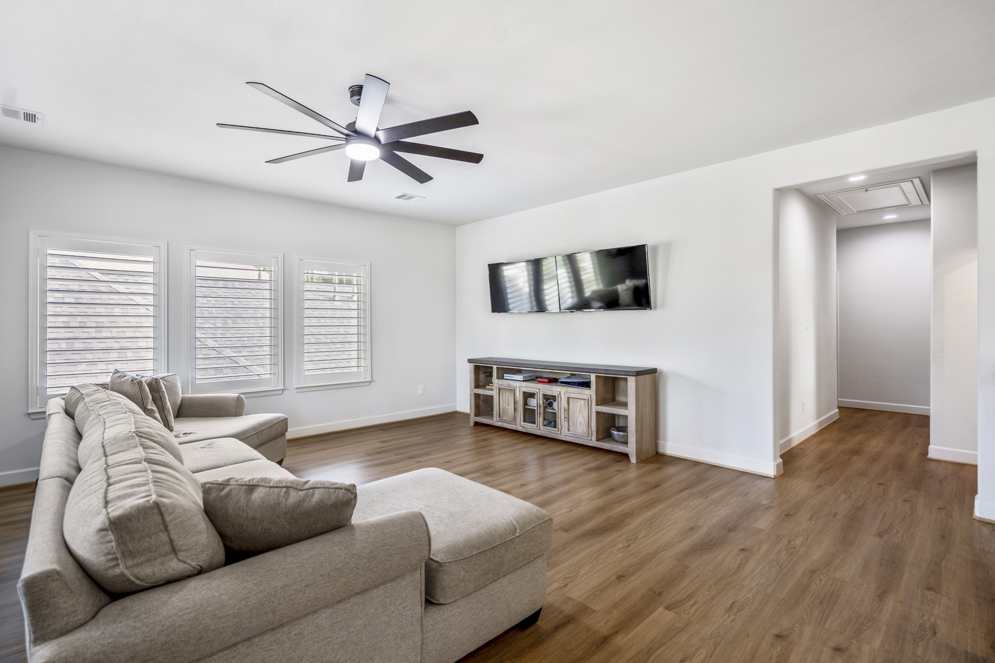 Ample natural light beams through the 2nd level living space showcasing upgraded LVP flooring throughout.