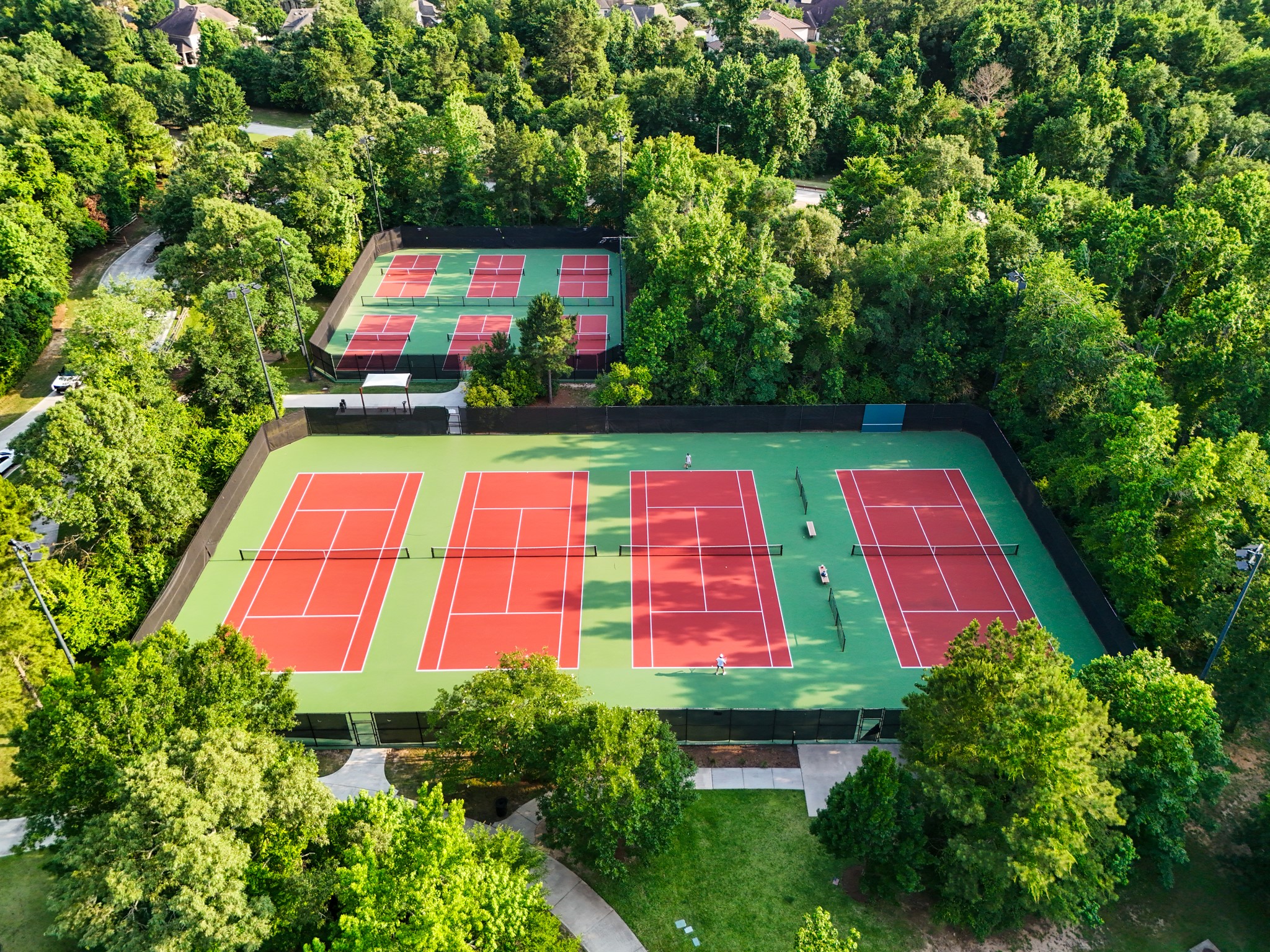 Multiple tennis courts offering a serene surrounding to stay active.