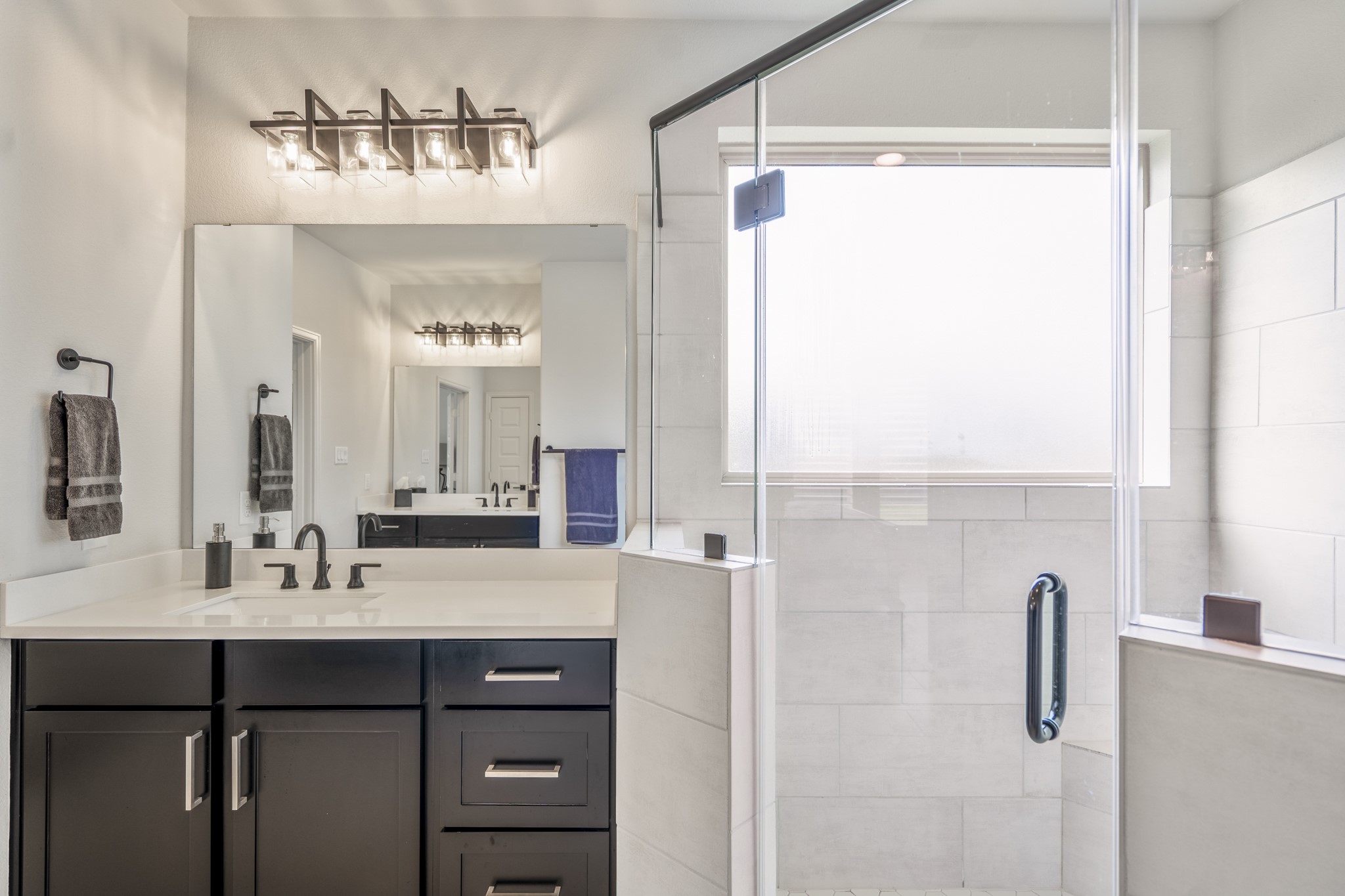 A closer look at the spacious shower but it's also equipped with a large walk-in closet and linen closet as well, offering plentiful storage.