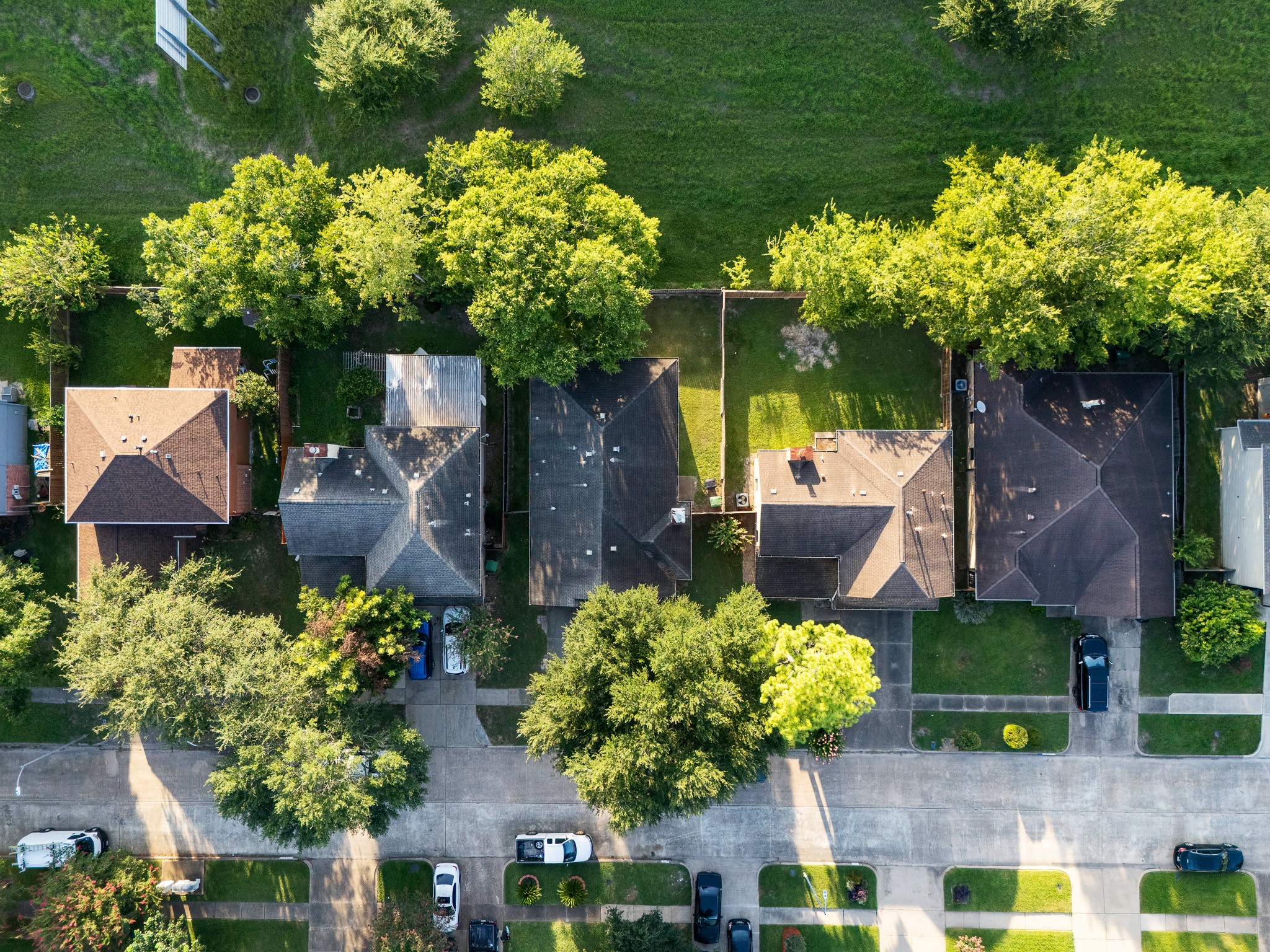 Charming neighborhood with well-maintained homes and lush greenery lining the streets, offering a serene suburban setting.