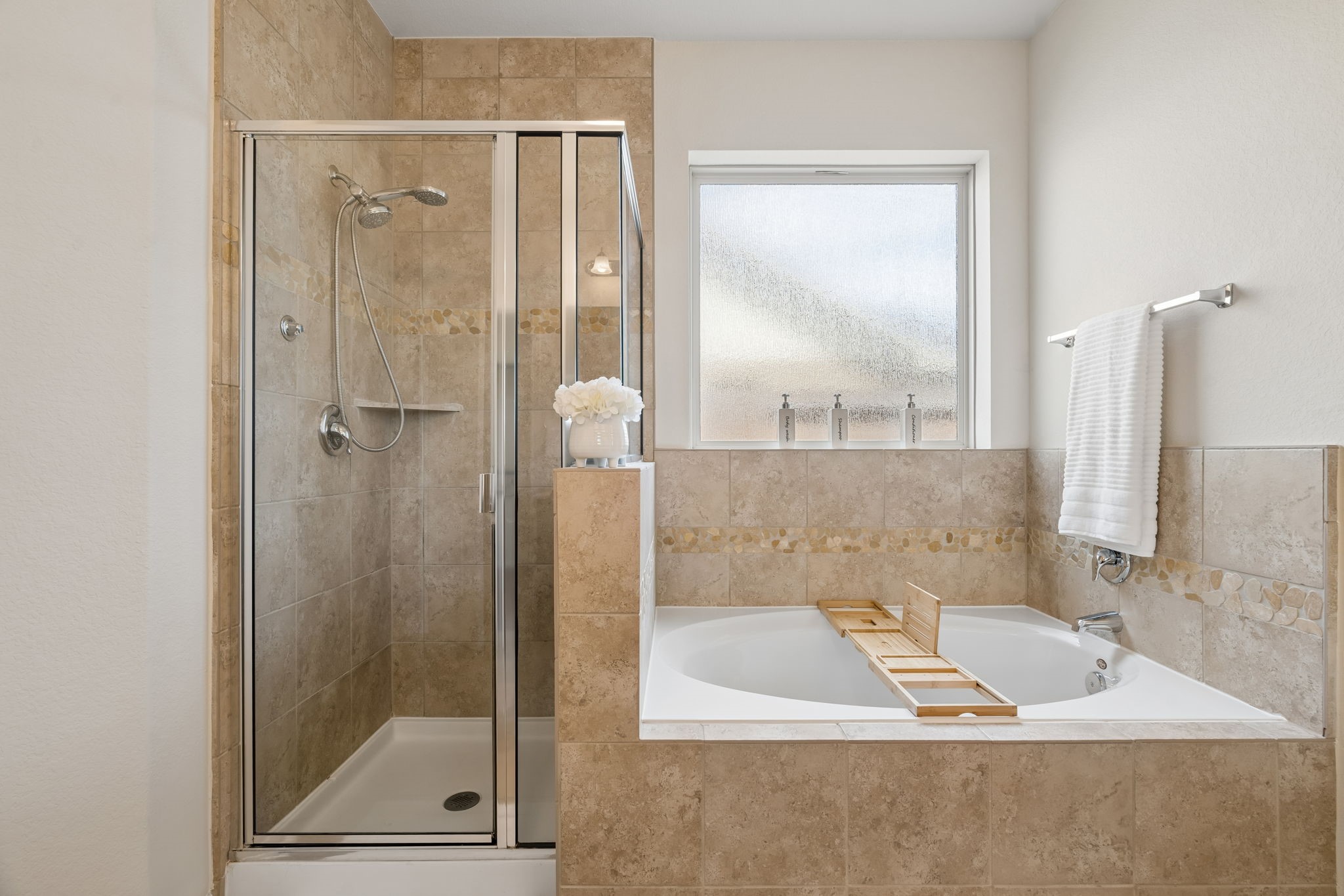 Large soaking tub featuring a sleek design, deep basin, and premium fixtures, perfect for a relaxing spa-like experience.