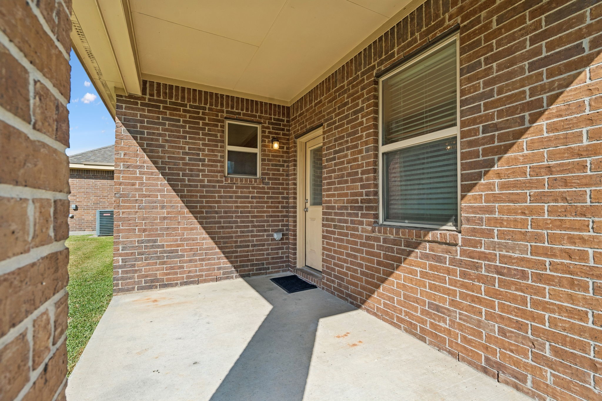 The brick-surrounded patio offers a comfortable setting for outdoor dining, a quiet morning coffee or simply enjoying some fresh air