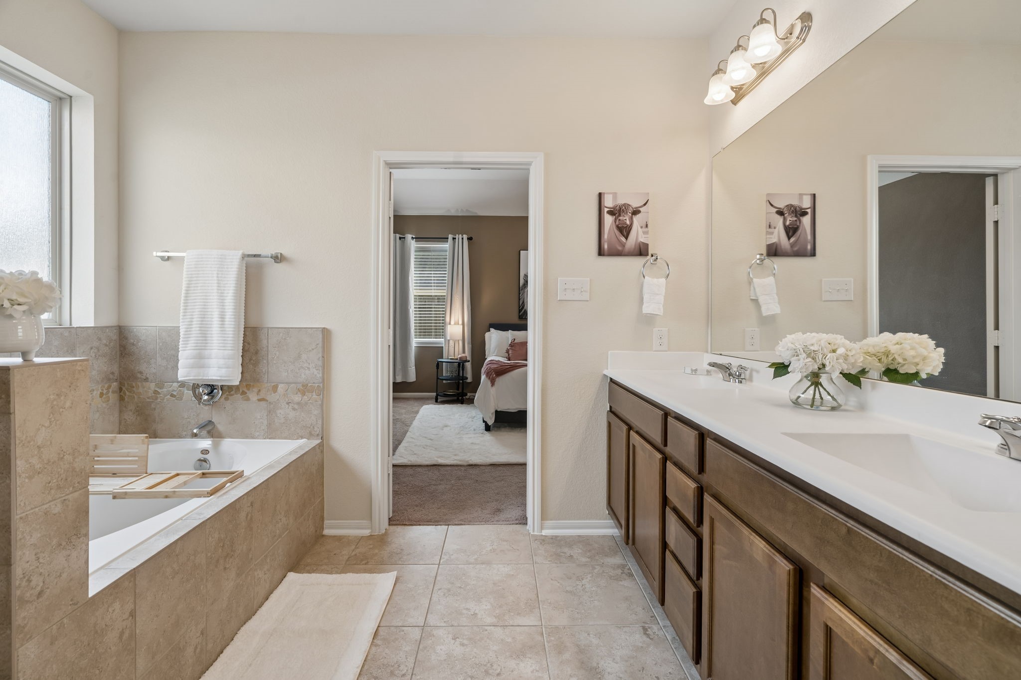 Large Primary Bathroom with double sinks, & separate bath/shower combo & large linen closet.