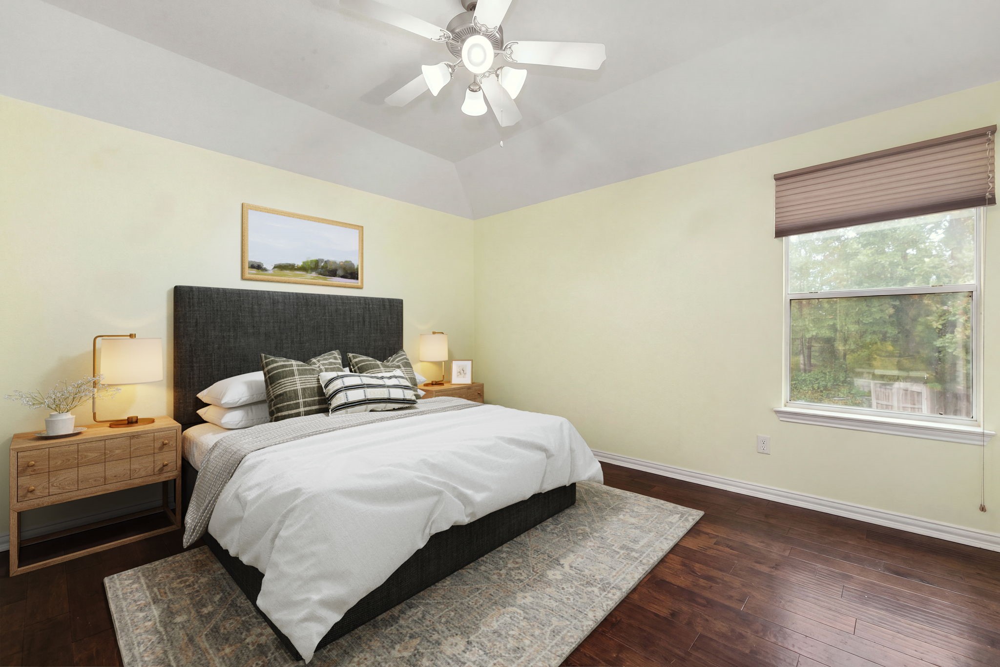 Perfect as a guest suite, secondary bedroom, or an extra hobby room, this space boasts elegant tray ceilings, a modern light-integrated ceiling fan, and soft neutral paint. The large window offers peaceful views of the surrounding greenery, completing a cozy and private layout.