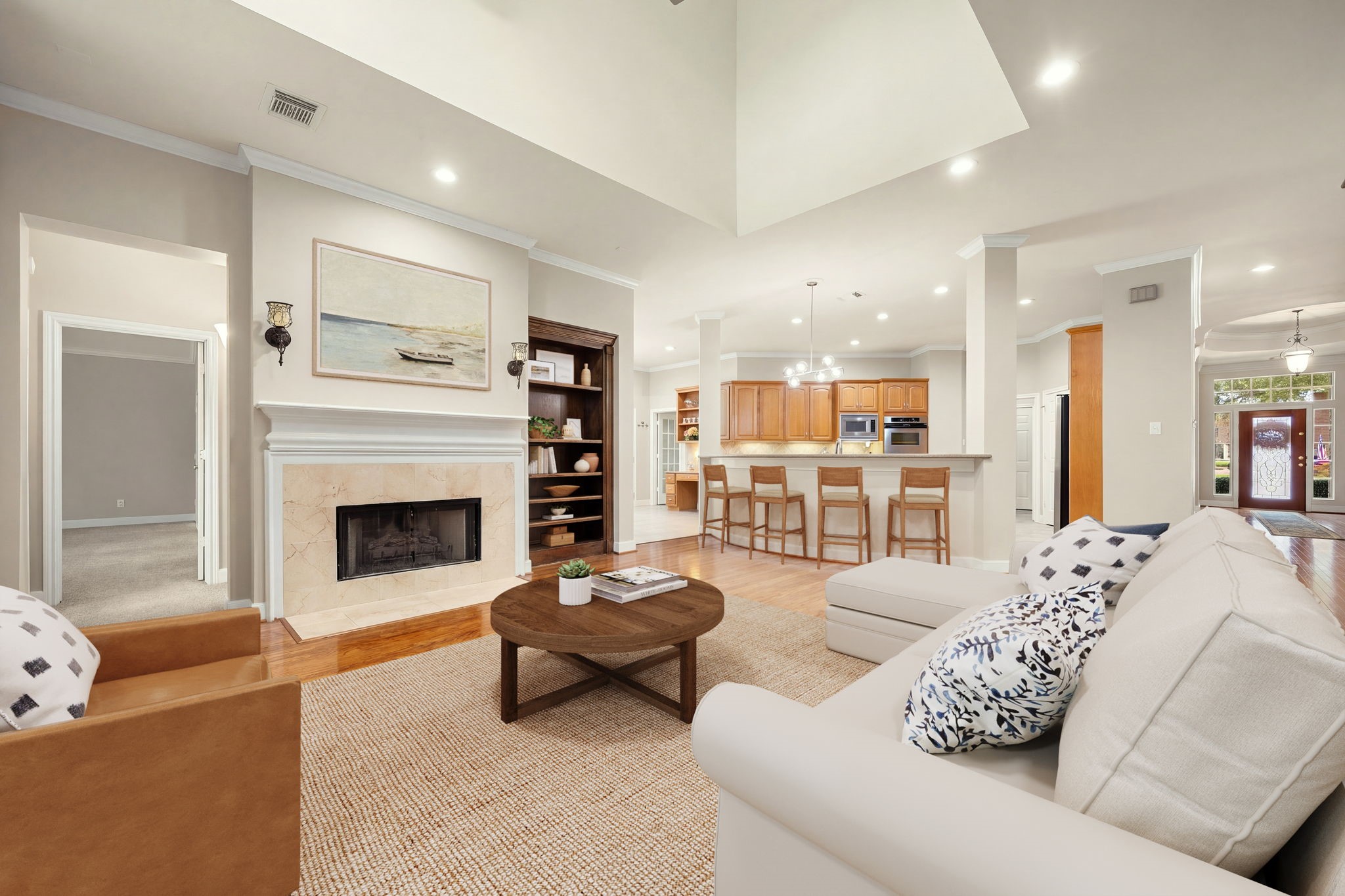 From this vantage point, you see the gorgeous modern fireplace surround, the soaring double-height architectural ceiling details, and the effortless, open pathway directly into the gourmet kitchen and formal dining spaces. From this vantage point, you see the gorgeous modern fireplace surround, the soaring double-height architectural ceiling details, and the effortless, open pathway directly into the gourmet kitchen and formal dining spaces.
