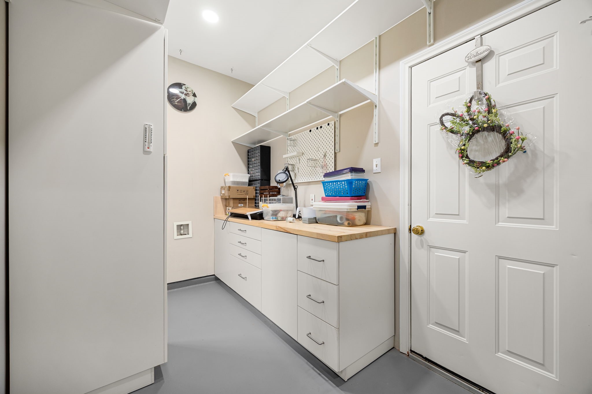 An organizers dream! This incredibly spacious bonus storage room features an expansive, custom built-in counter with a long row of drawers and storage cabinets underneath. Perfect as a crafting station, climate-controlled holiday storage, or a dedicated workspace, this versatile bonus room offers the ultimate functional flexibility.