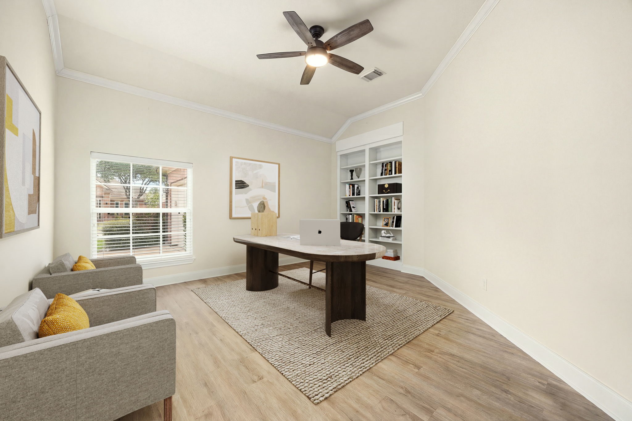 This dedicated home office space features elegant French doors for productivity and privacy. Designed with handsome wood-look flooring, crisp neutral walls, and a modern ceiling fan, the versatile layout offers ample room for a large executive desk, storage, and cozy client seating beneath a bright window looking out to the front yard.