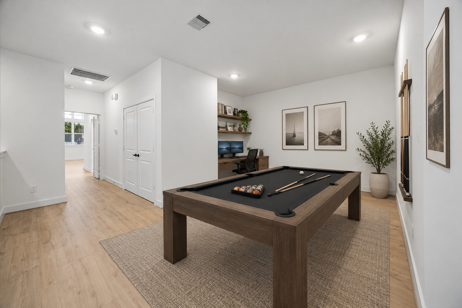 Digitally staged versatile flex room showcasing the possibilities for a home office and game room, complete with a pool table and dedicated workspace.