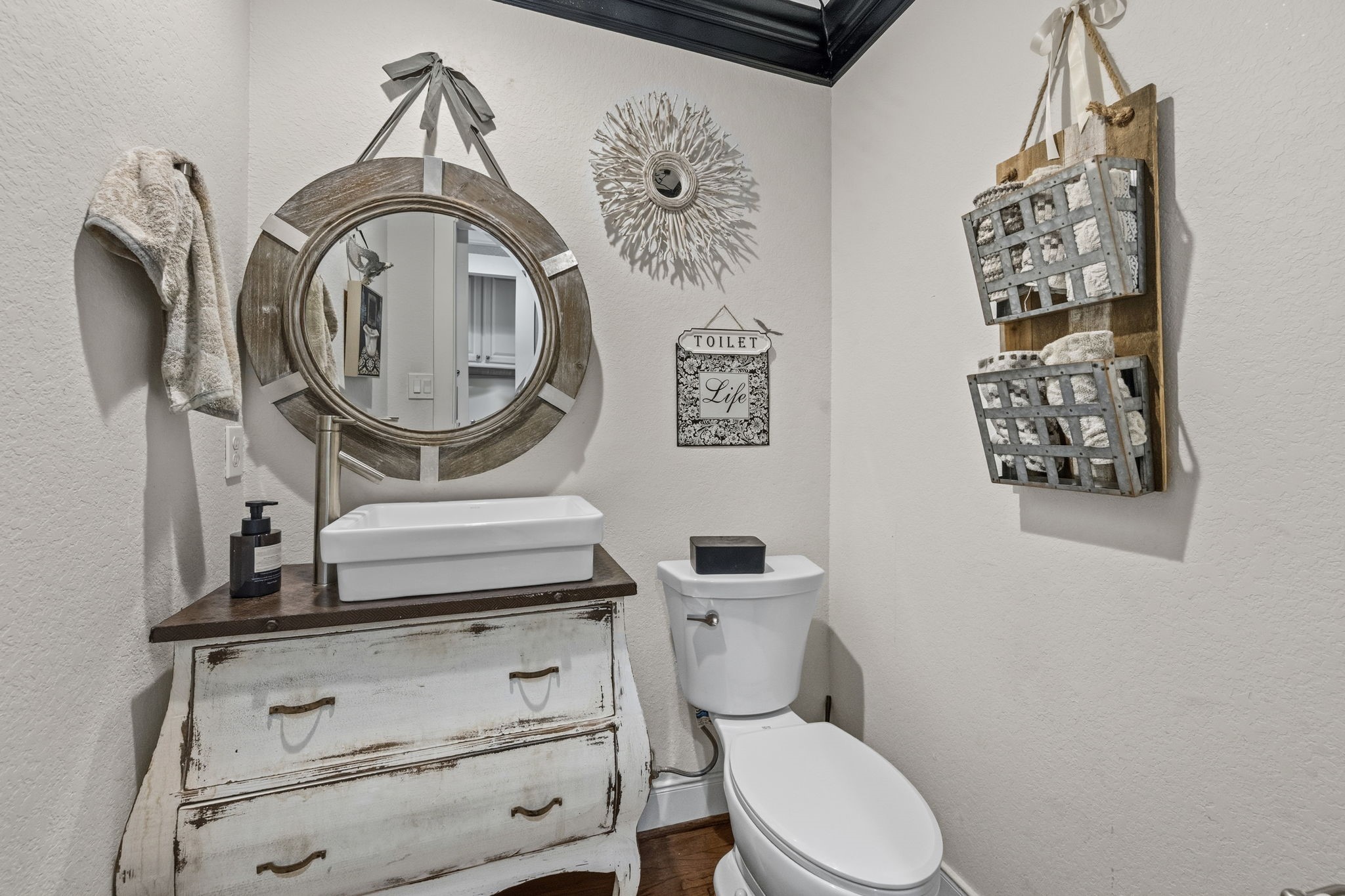 A powder bath with a decorative mirror.