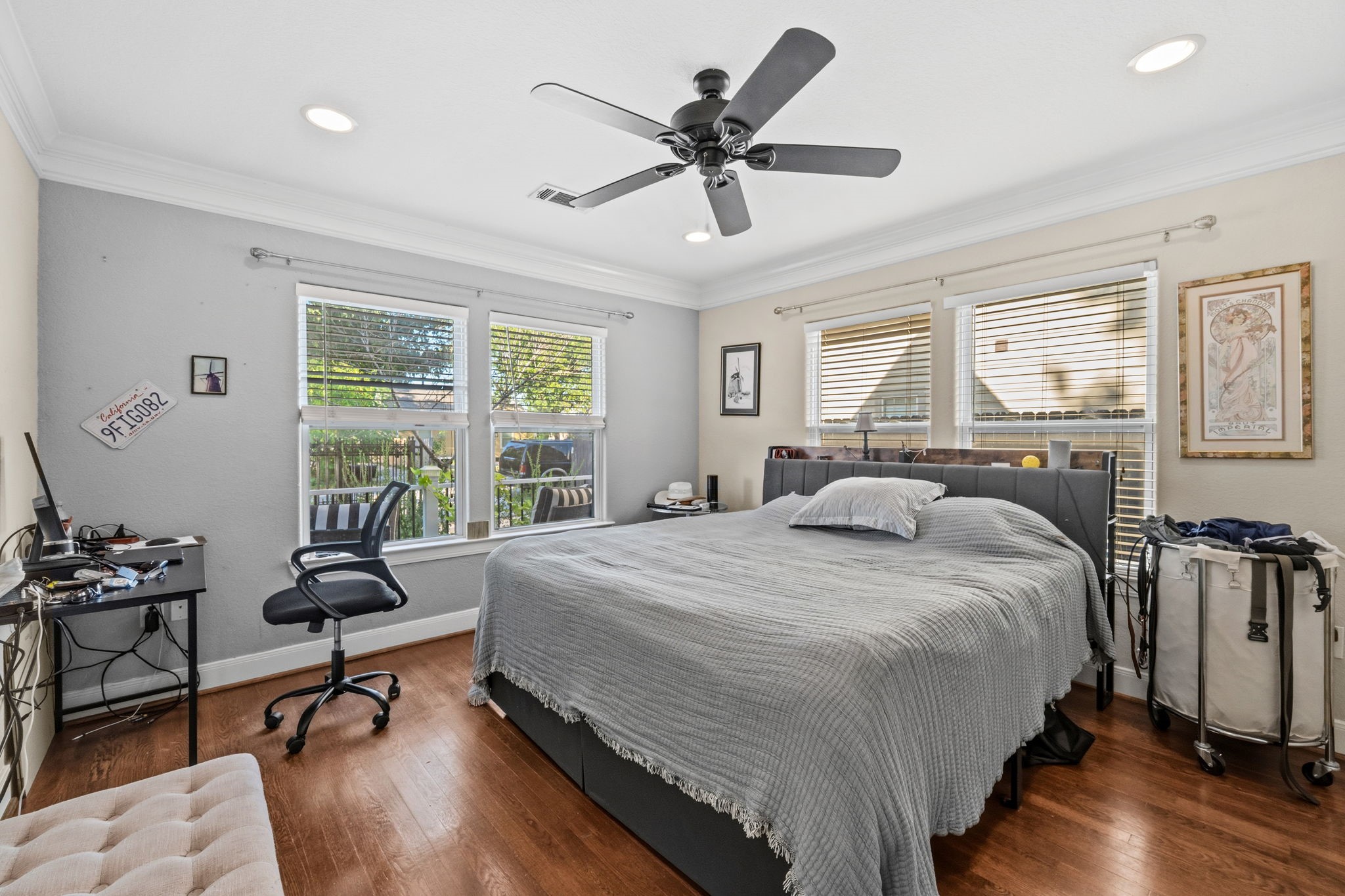 A secondary bedroom with a ceiling fan and bright window.