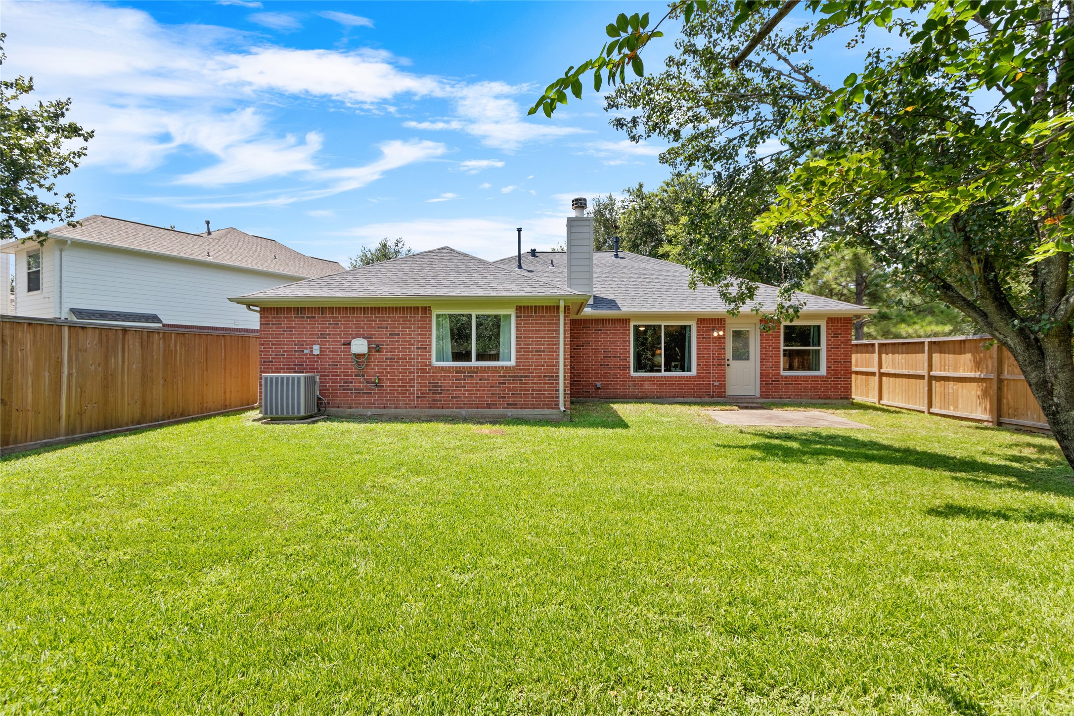 Charming brick home with a spacious fenced backyard.