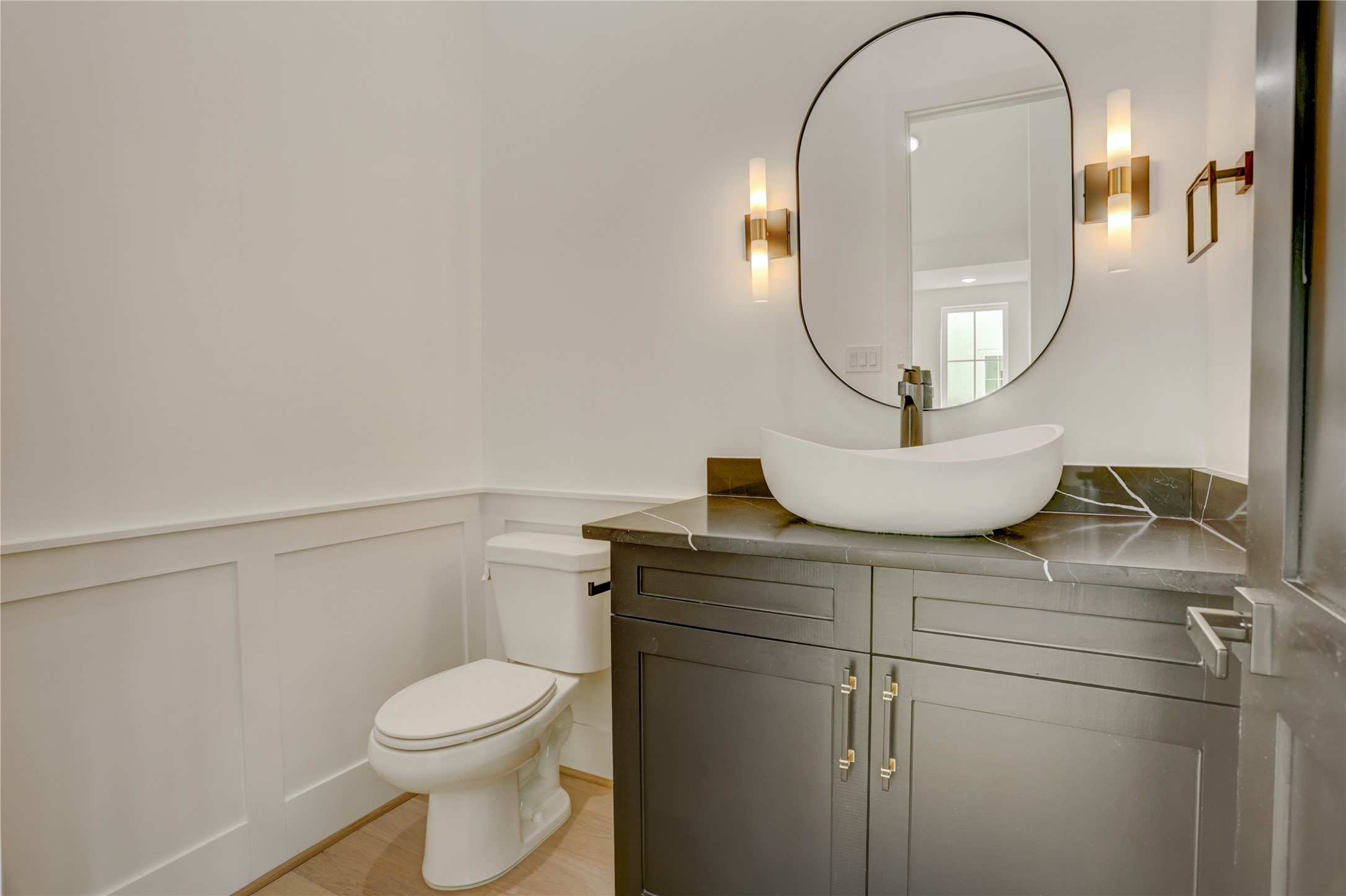 The powder bathroom is located between the kitchen and living area.