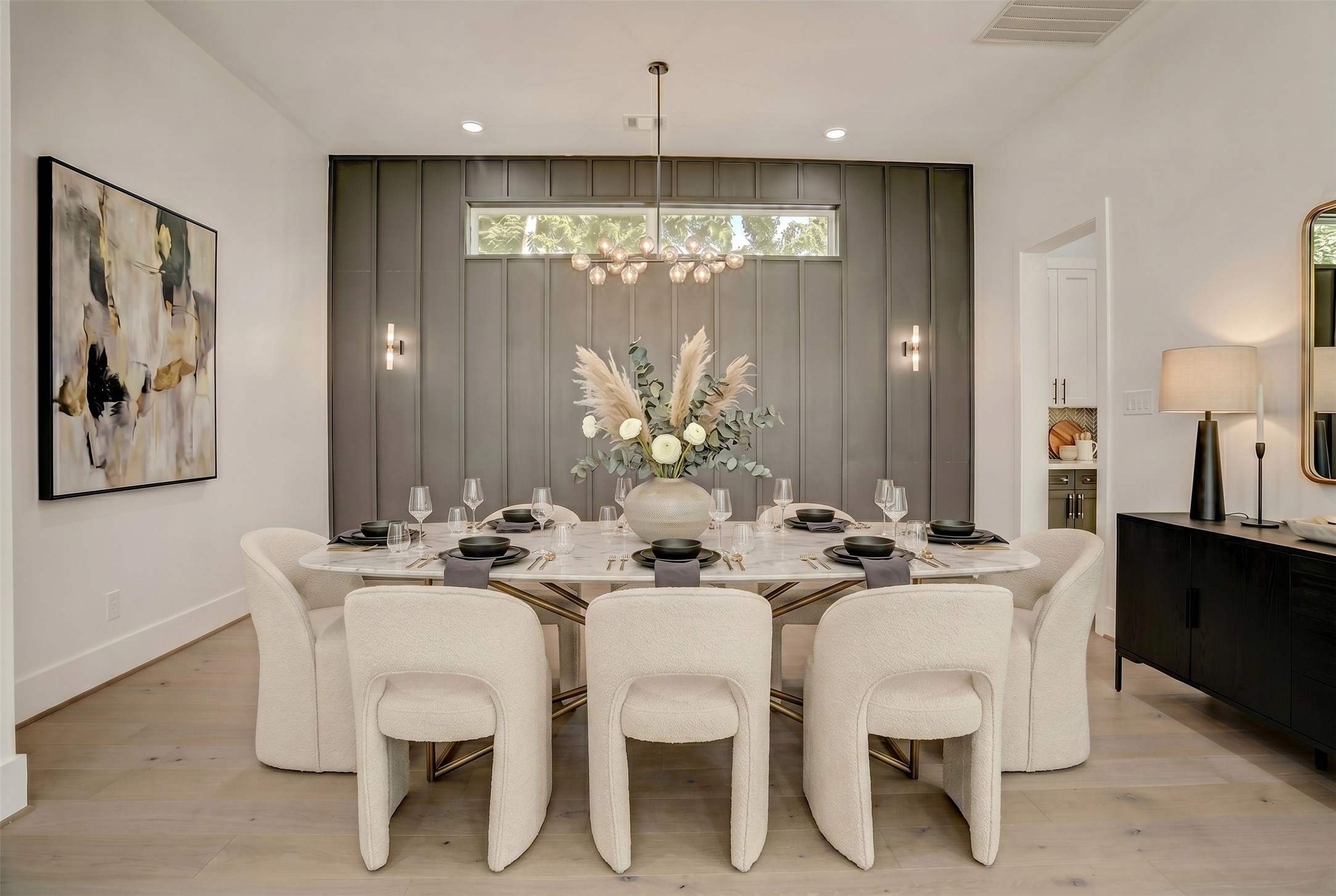 Completely open to the living area is a private dining room with stunning accent wall. Virtually staged photo. Completely open to the living area is a private dining room with stunning accent wall. Virtually staged photo.